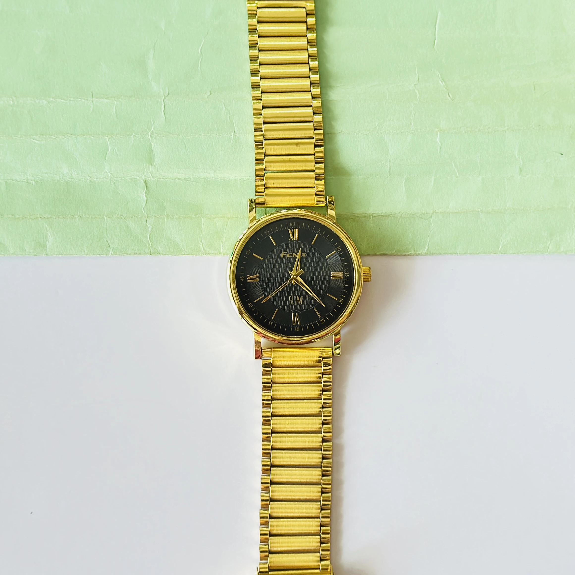 Gold coloured analogue watch
