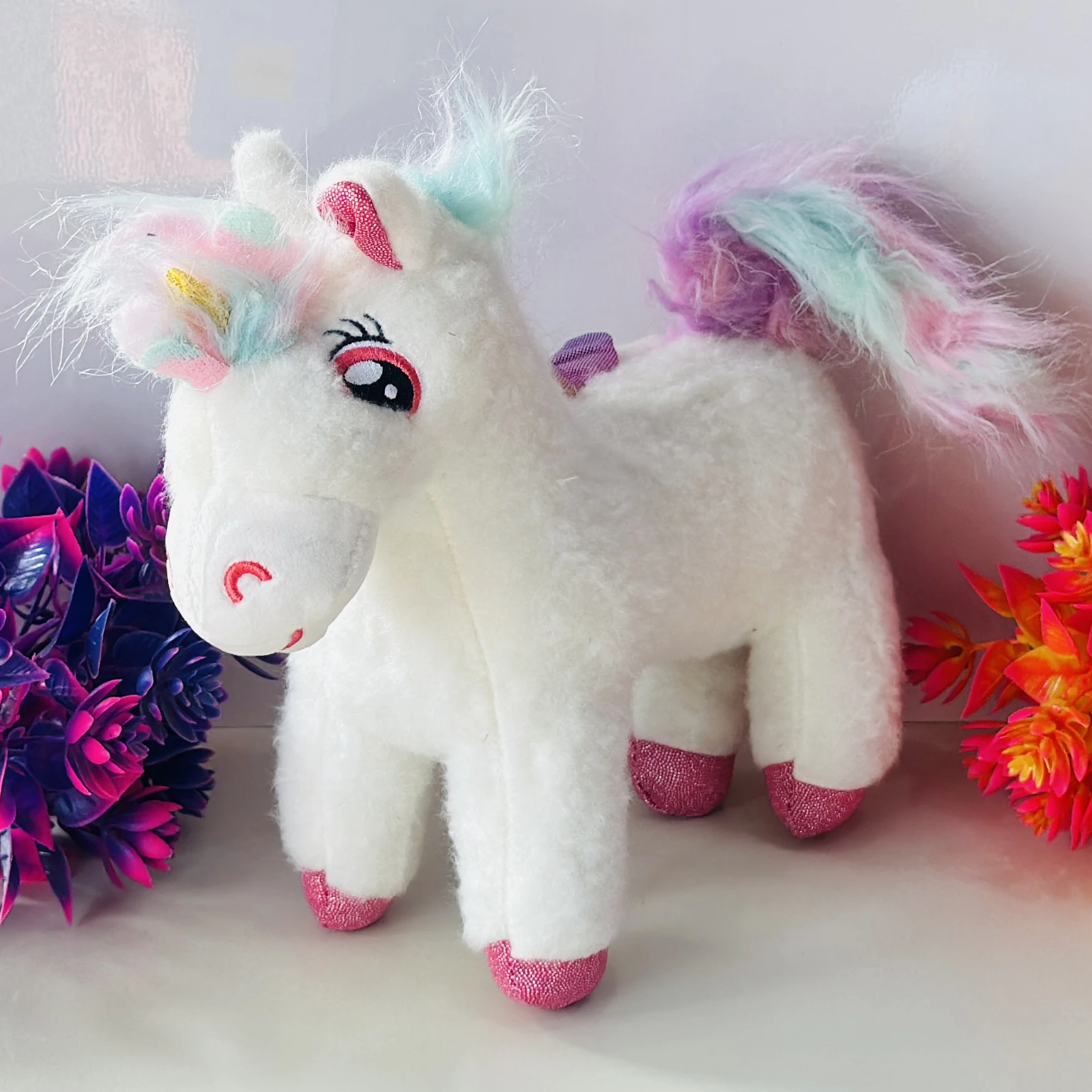 white unicorn plush toy.