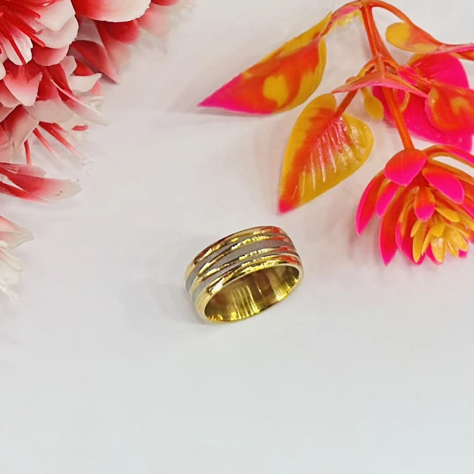 Gold and silver-toned stainless steel dual-edge wedding band with a brushed finish