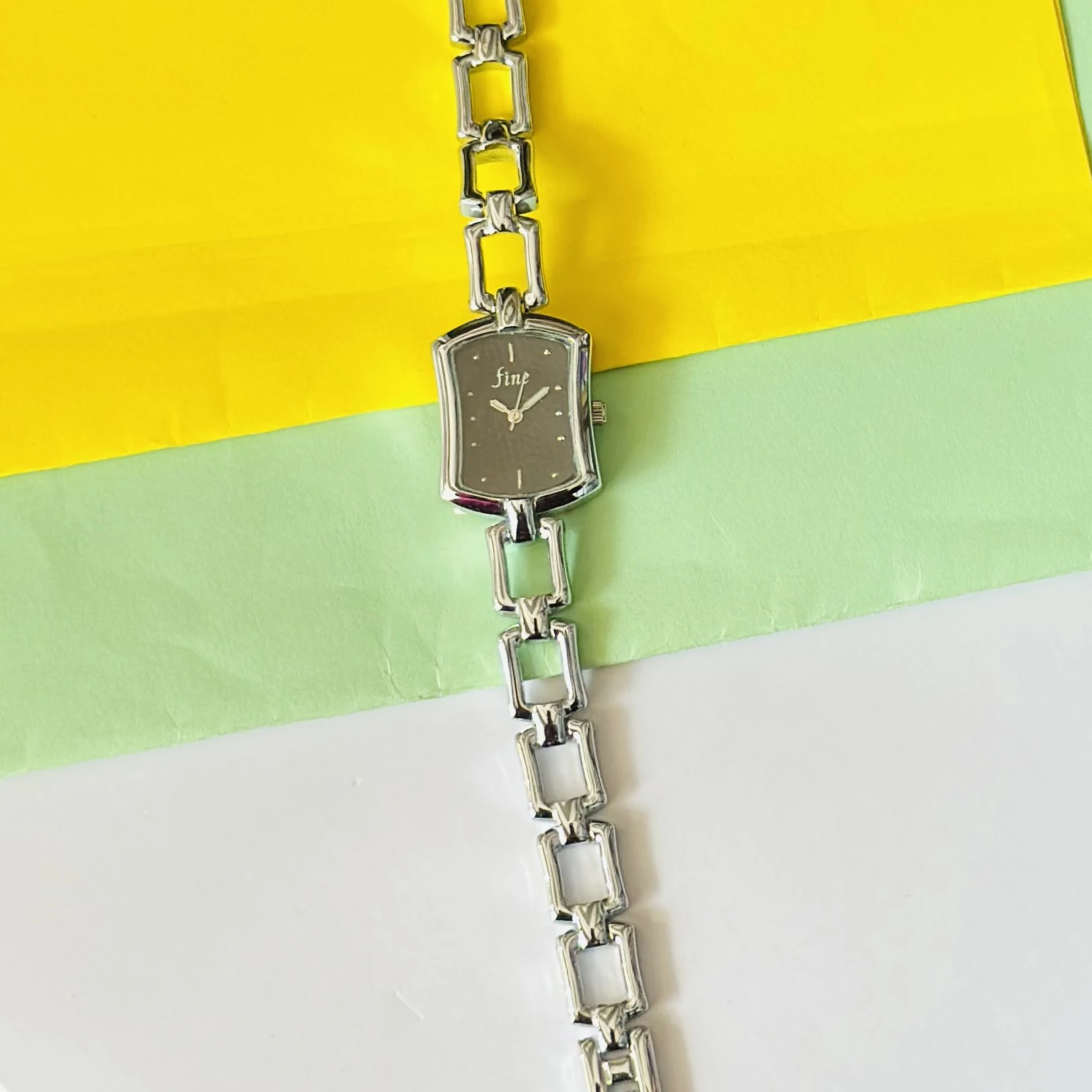 women's analog watch with a silver-tone metal case and a matching link bracelet strap