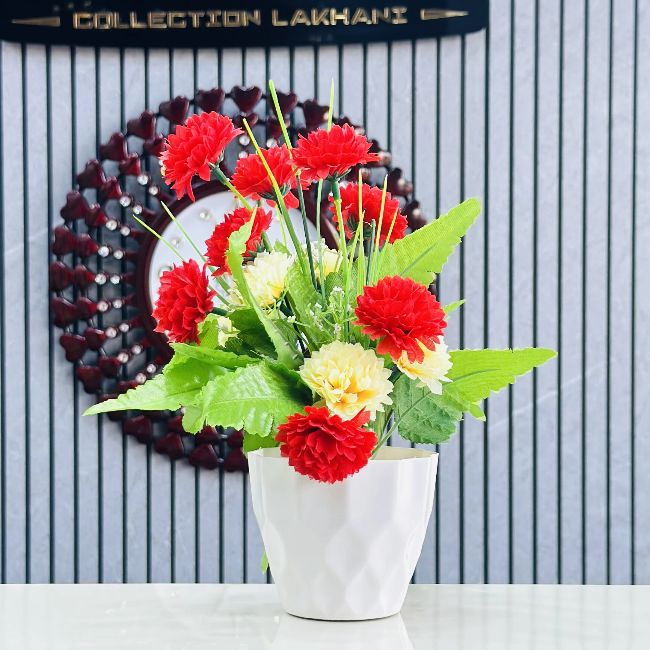 carnation flower arrangement in a white ceramic-like pot.