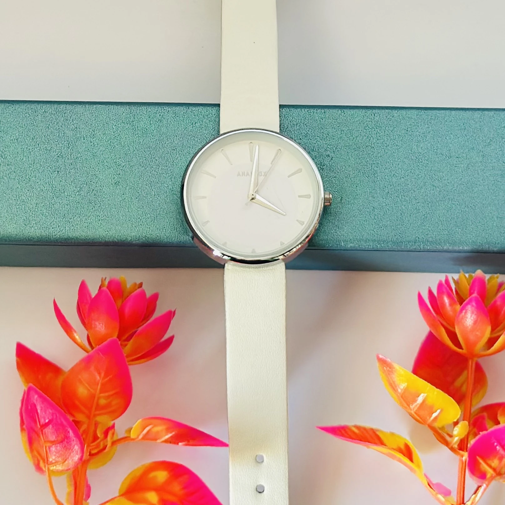 White Focus quartz analog watch for women with a white leather strap.