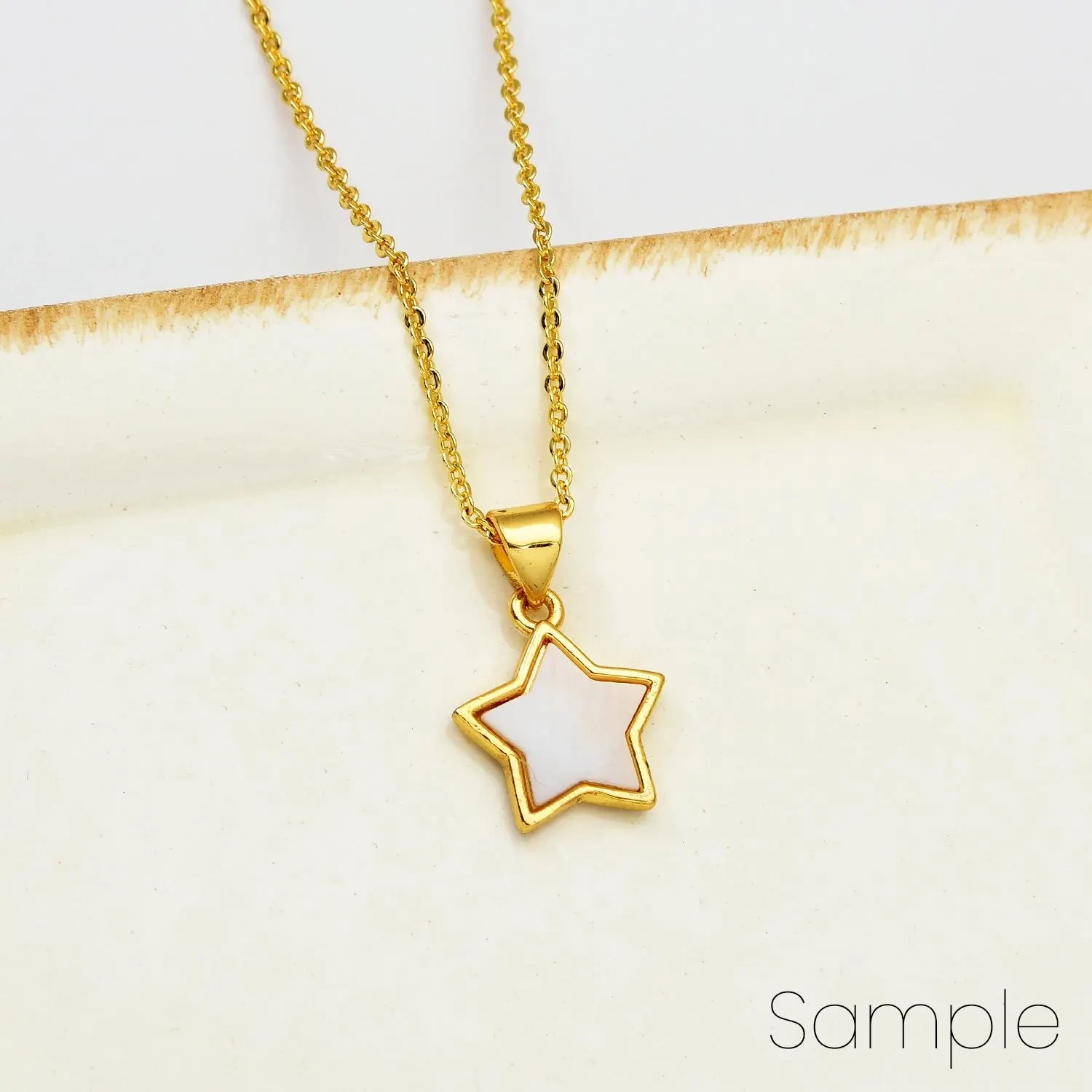 Gold plated shell-embossed star pendant necklace.