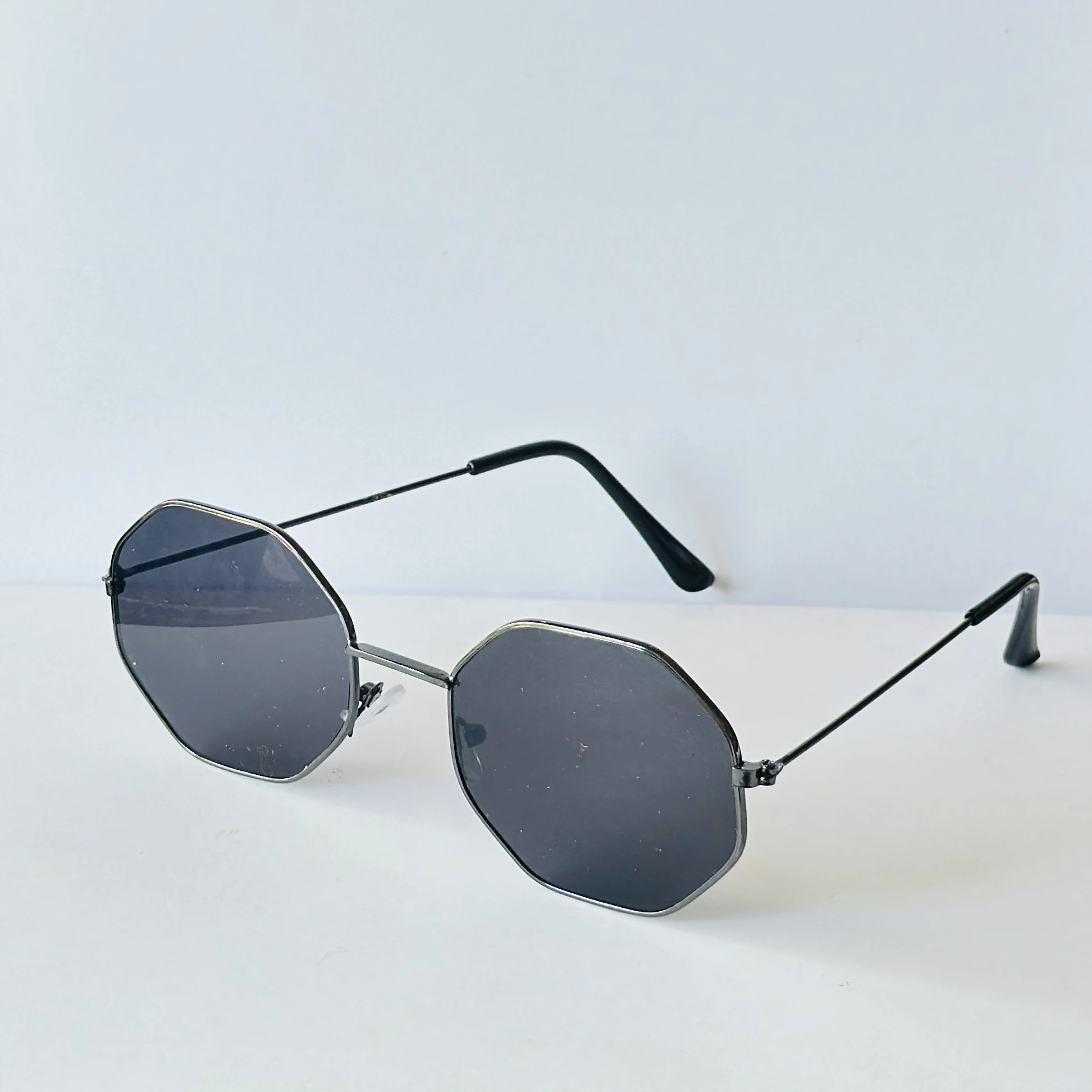 sunglasses appear to be similar to Vincent Chase Octagon Metal Frame Sunglasses