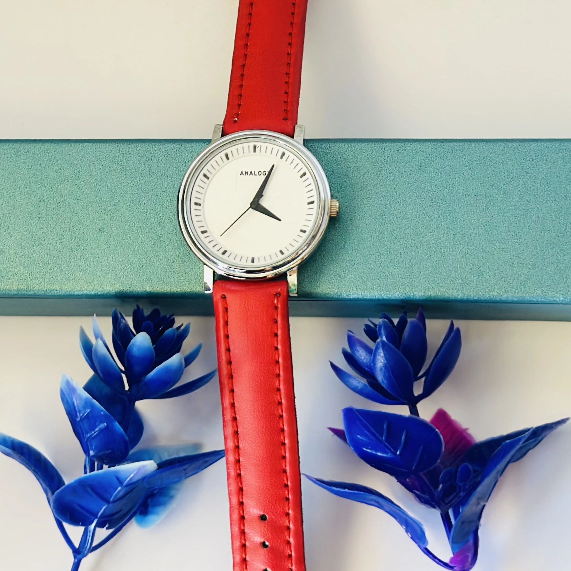 Red  analog watch with a red strap.