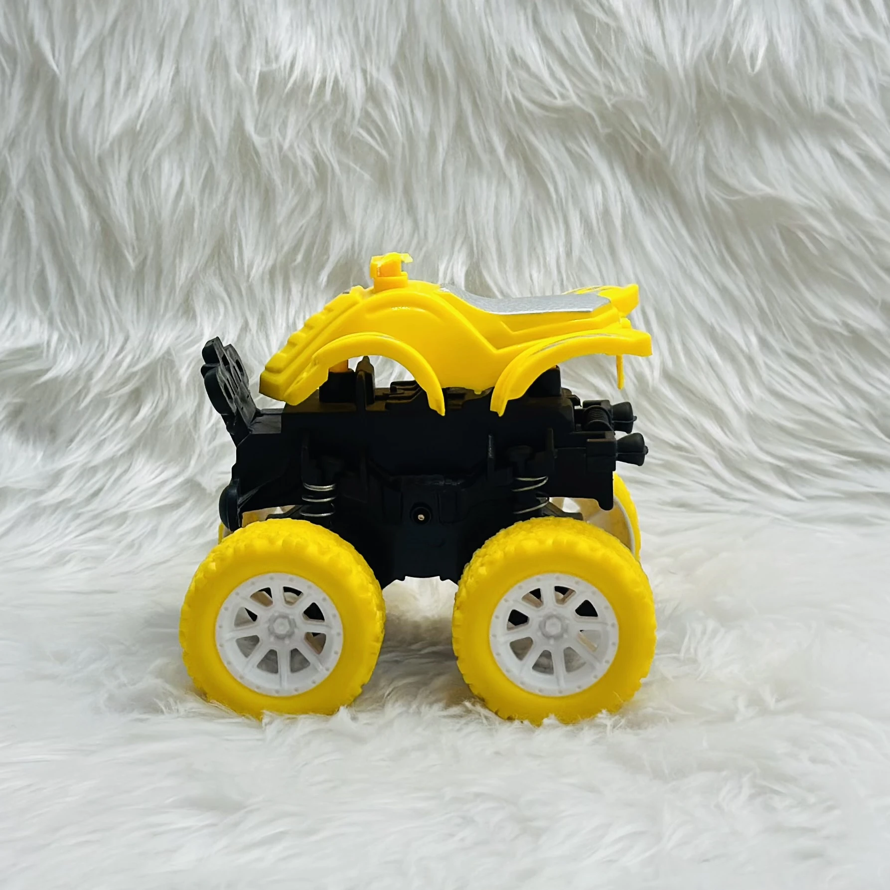yellow friction-powered monster truck toy.