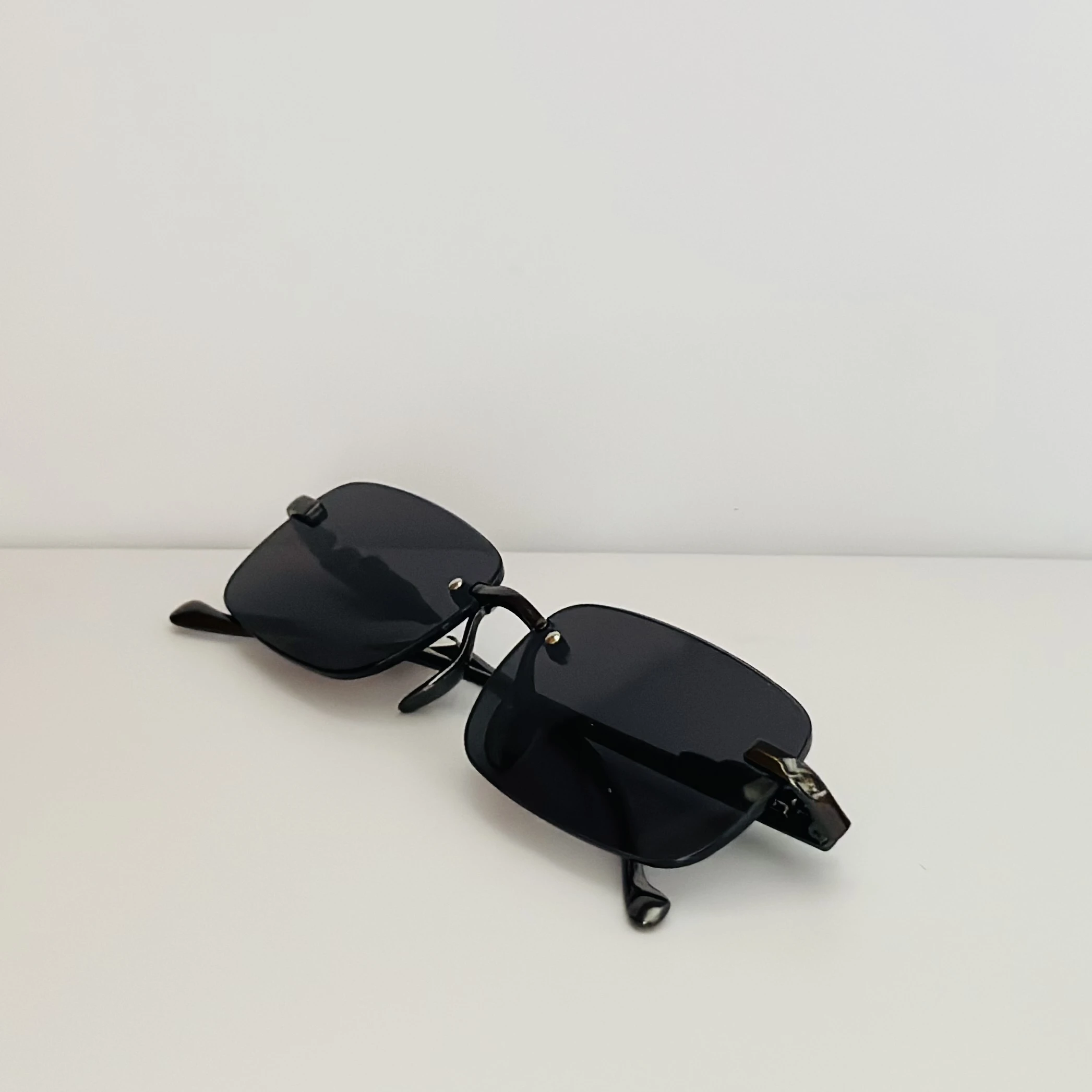 Creature Mc Stan rimless unisex rectangular sunglasses in black.