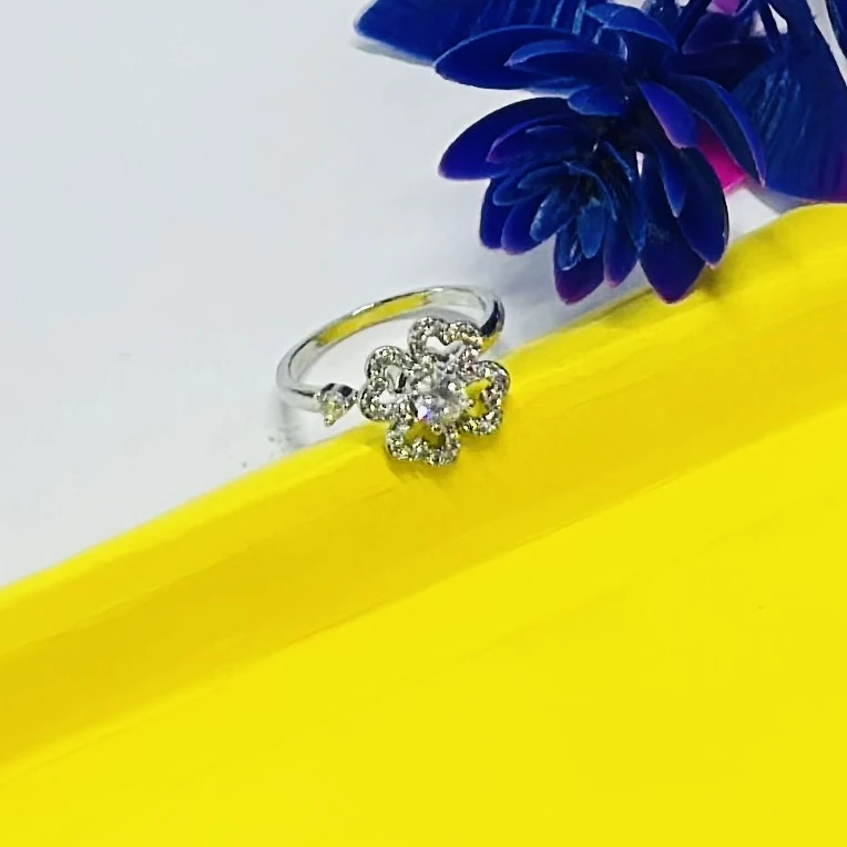 An adjustable silver-toned flower ring