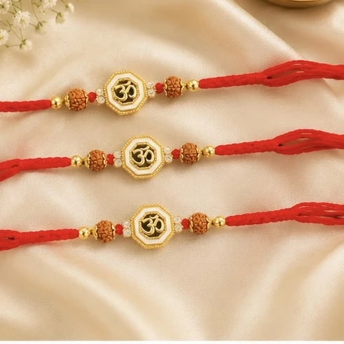 Raksha Bandhan rakhis with gold-plated Om symbols and red threads.