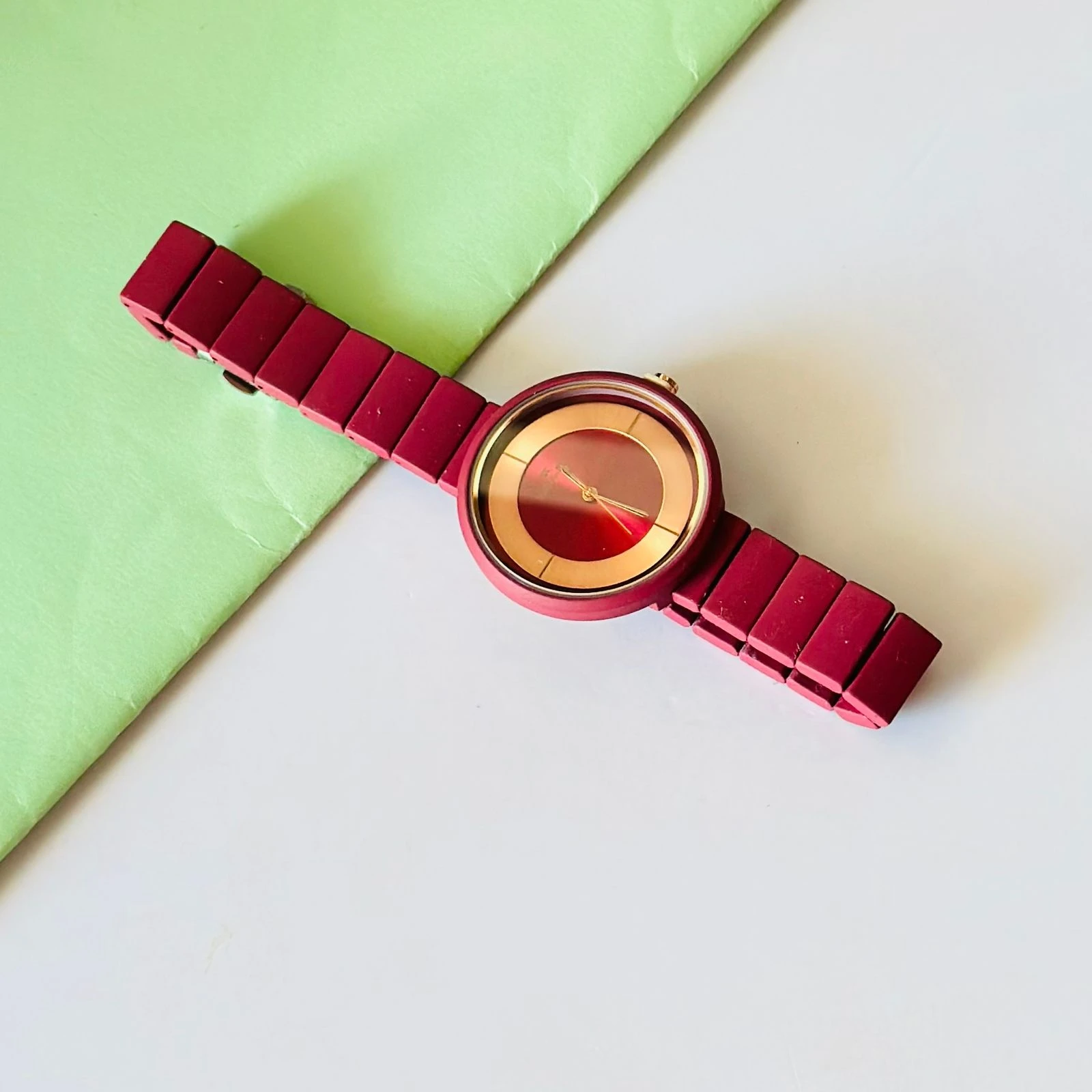 burgundy or red analogue watch for women, possibly from brands like Fastrack or Watchstar