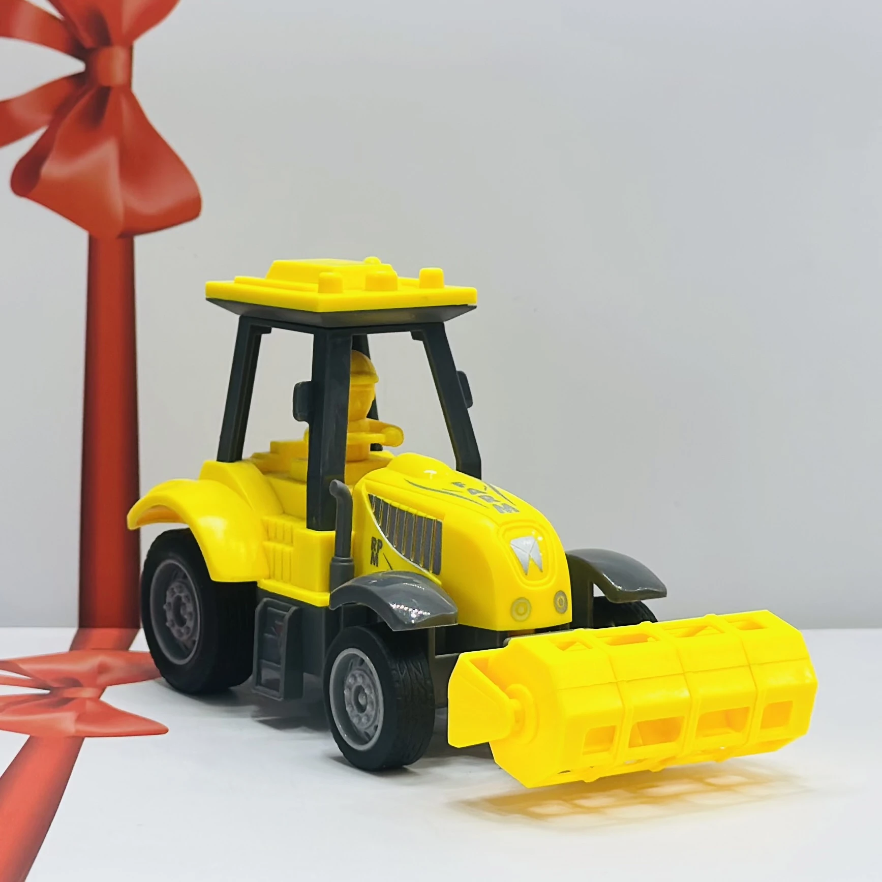 Yellow plastic toy tractor