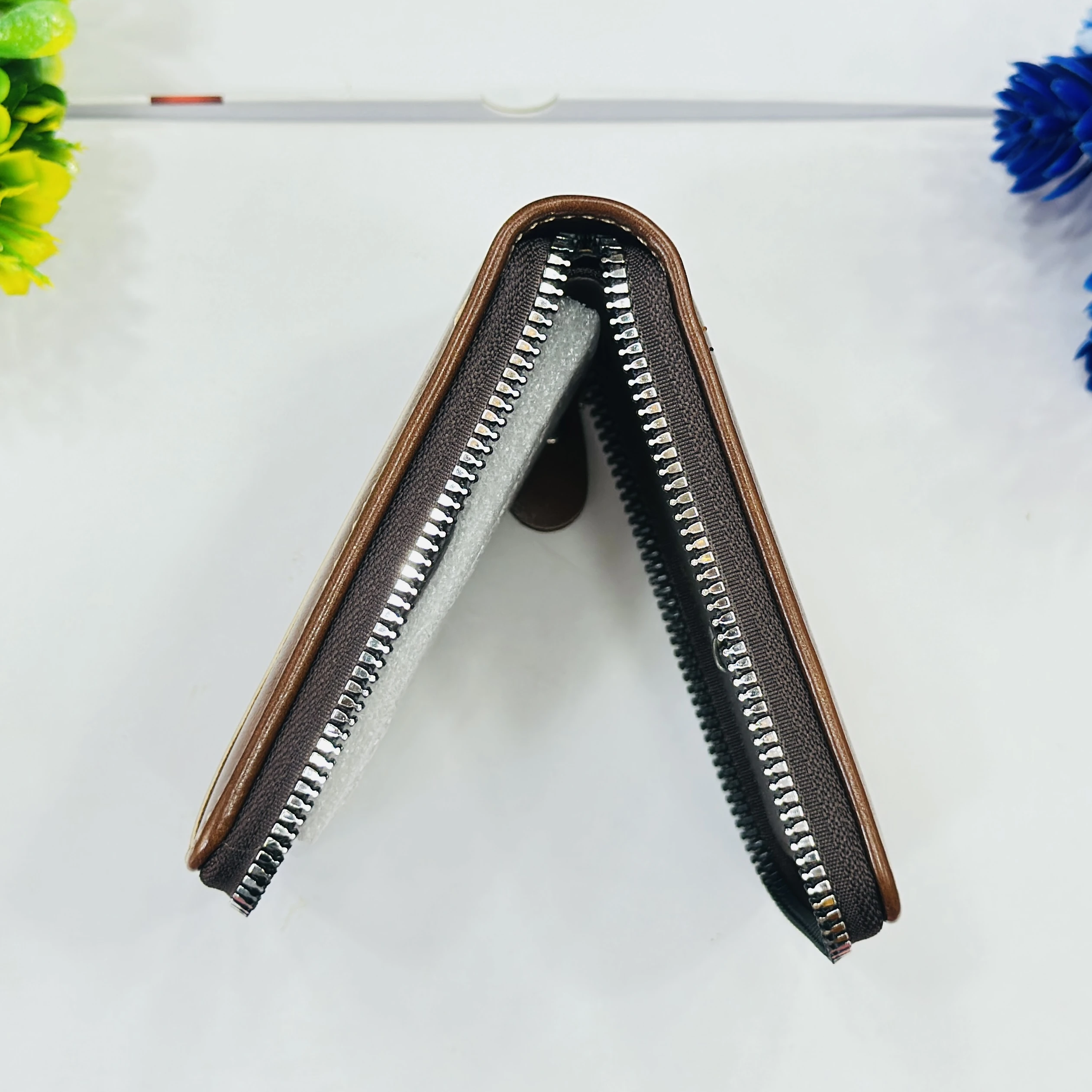 Balisi brand men's wallet is a brown zip-around PU leather wallet.