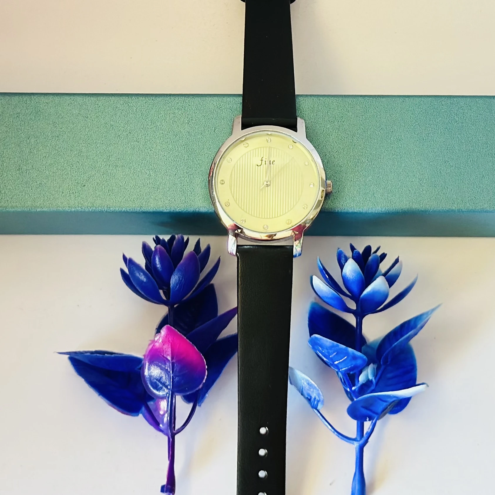 women's round leather watch in silver and black with a white dial