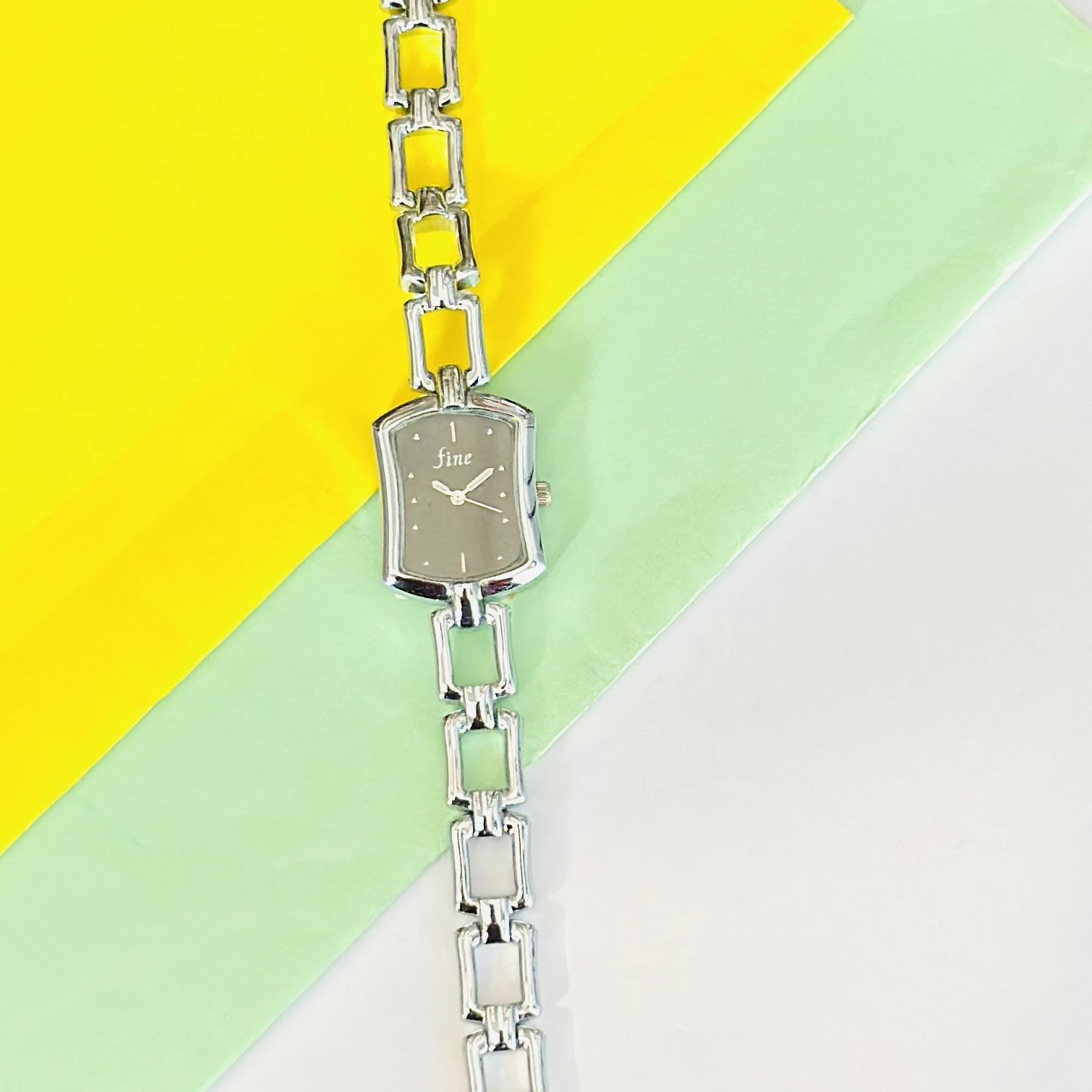 women's analog watch with a silver-tone metal case and a matching link bracelet strap
