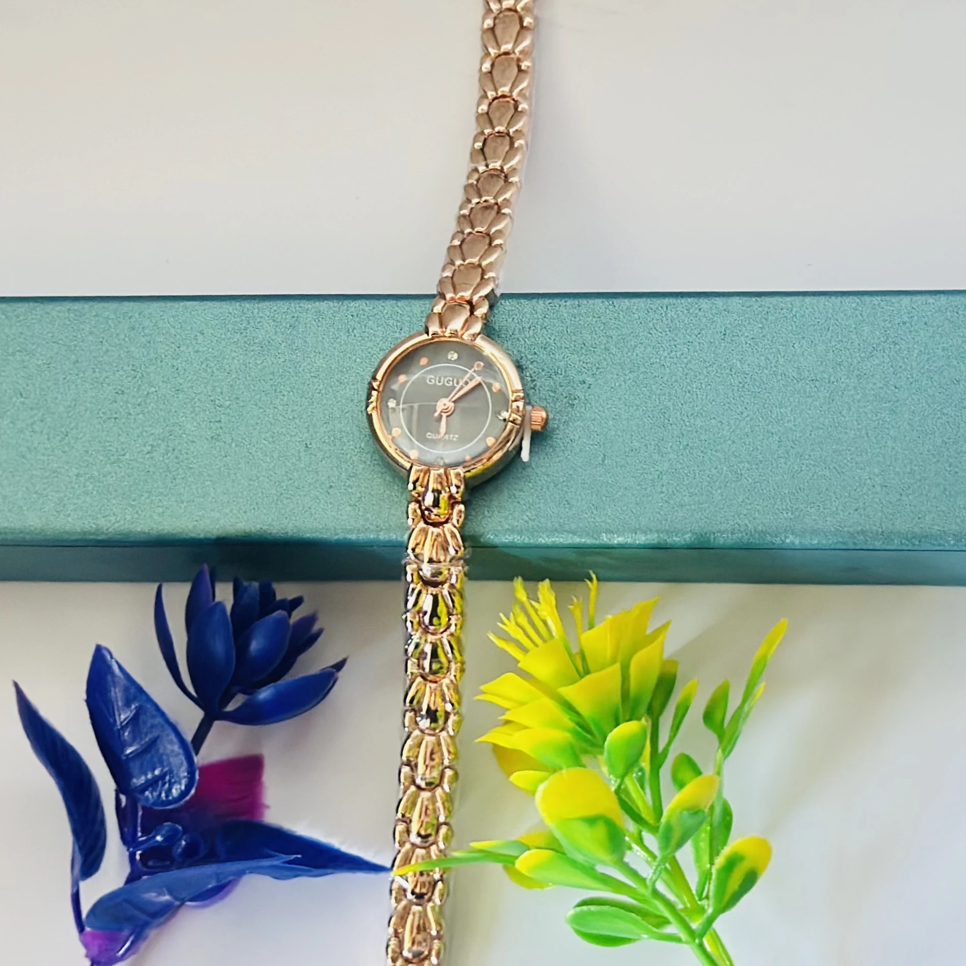 analog women's watch with a rose gold-toned metal strap.