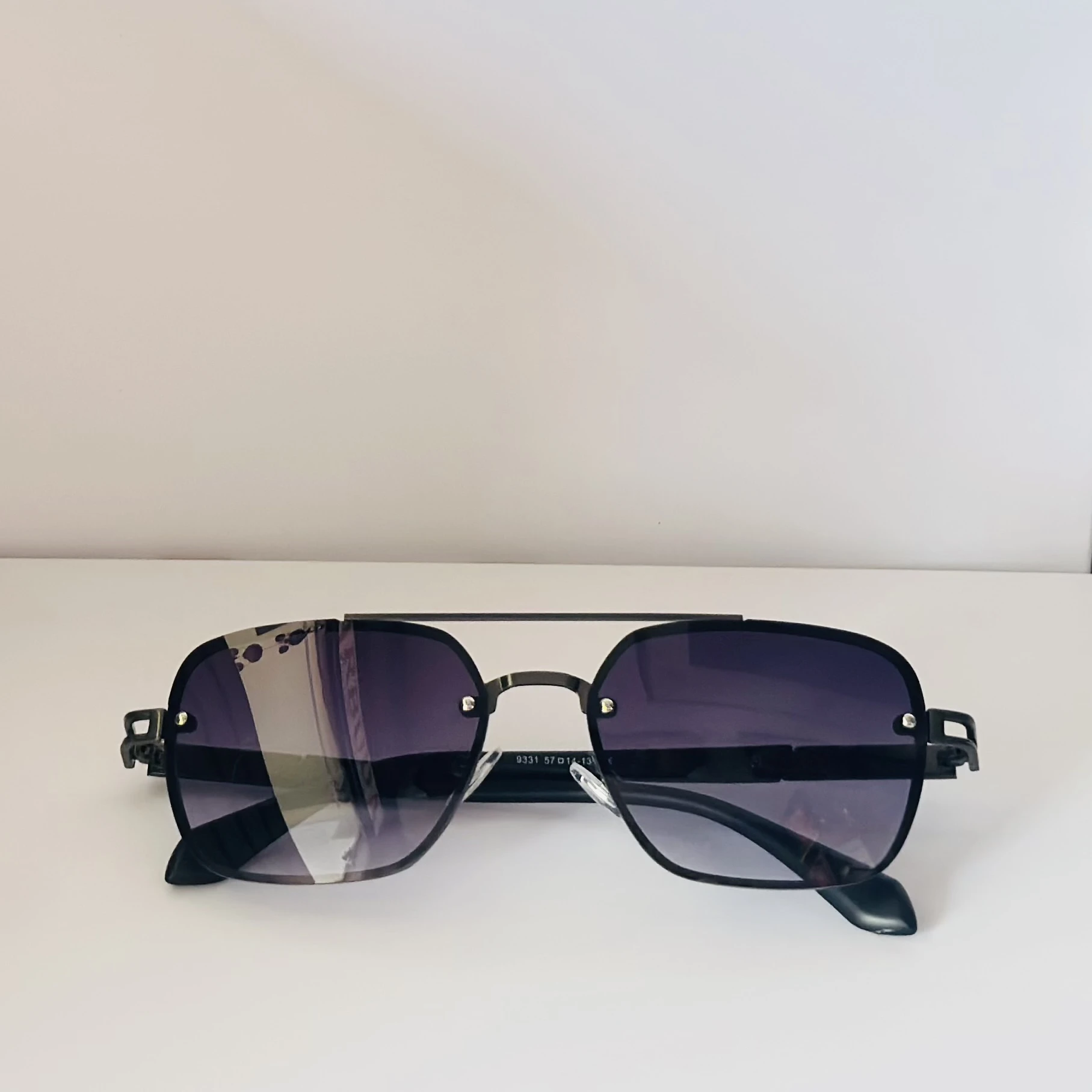 pair of Maybach square-style sunglasses with a black metal frame and dark gradient lenses