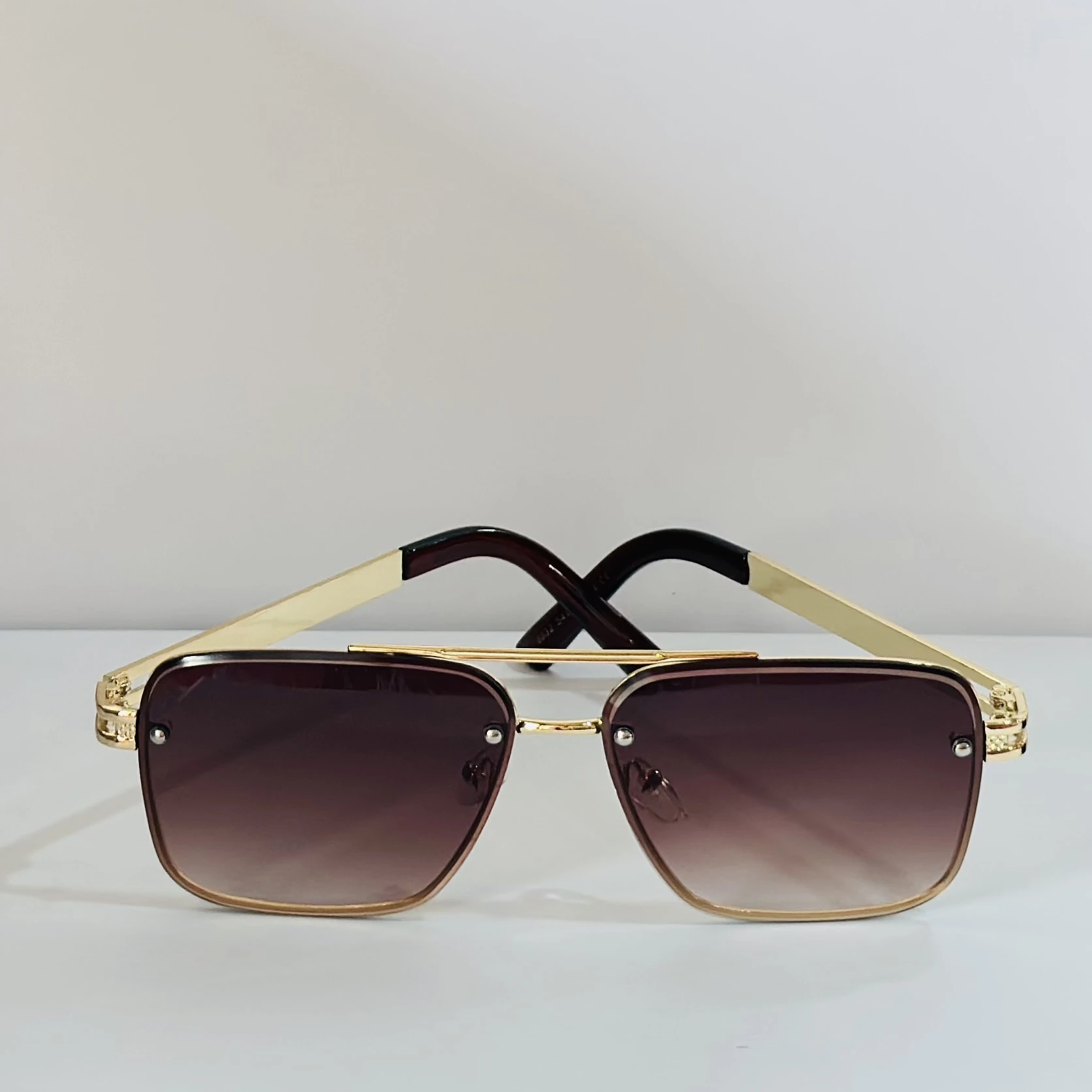 pair of Maybach aviator sunglasses with a gold-tone frame and brown gradient lenses