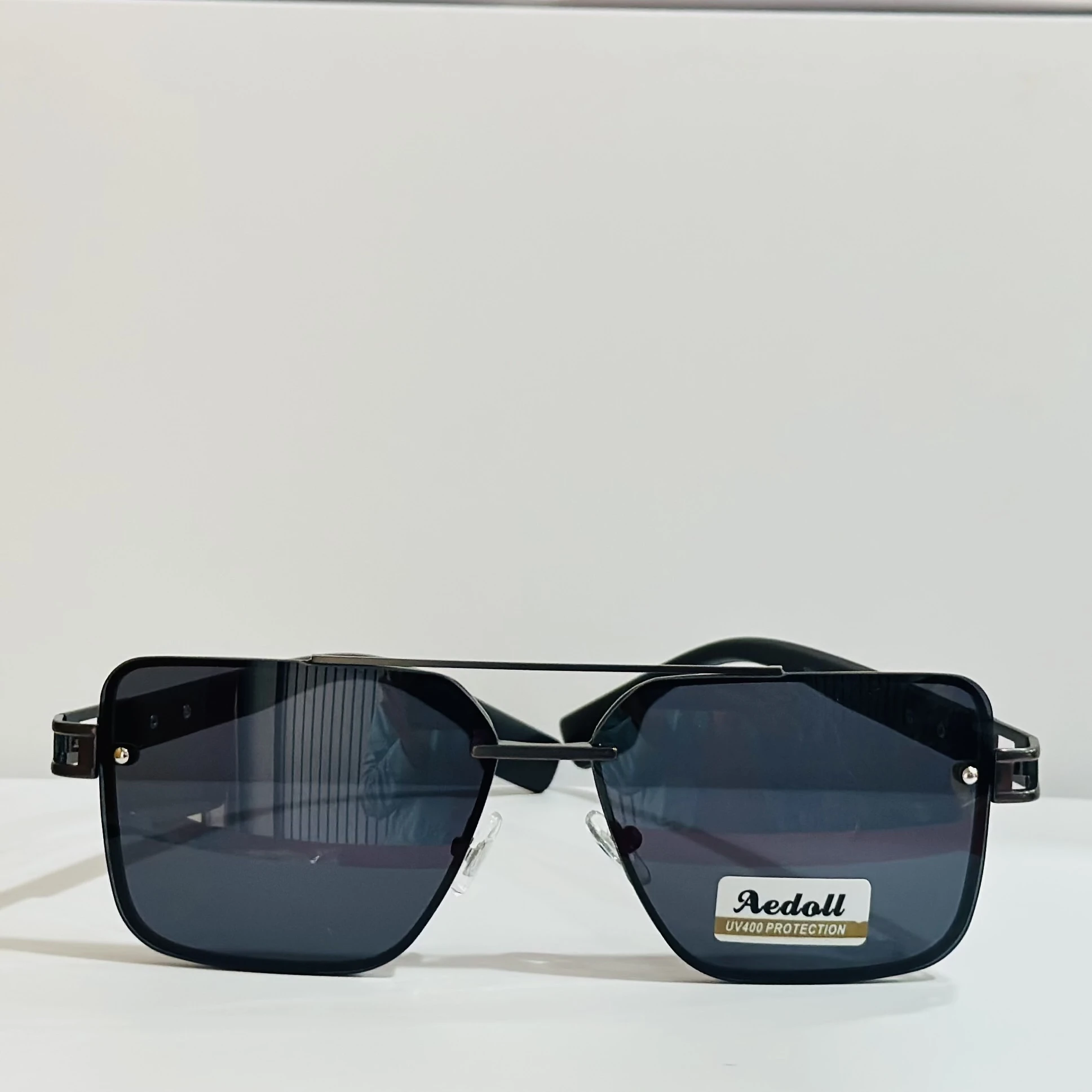 pair of square aviator sunglasses with a black metal frame and gradient lenses.