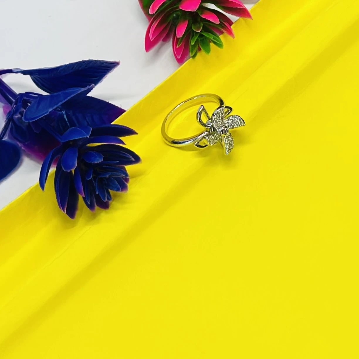 silver floral-shaped ring adorned with sparkling cubic zirconia or diamonds.