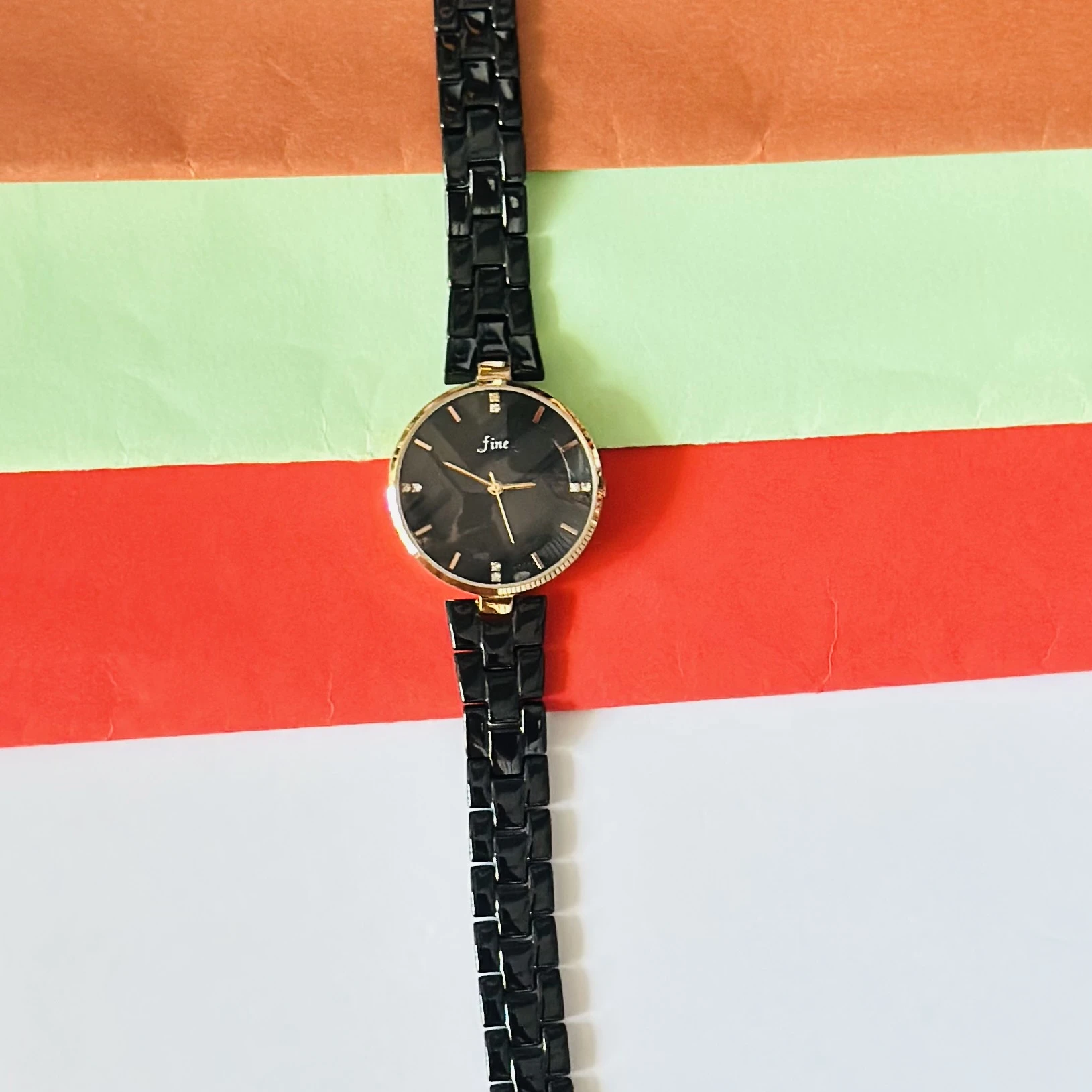 LeForce analog women's watch with a black dial, gold-plated case, and black bracelet strap