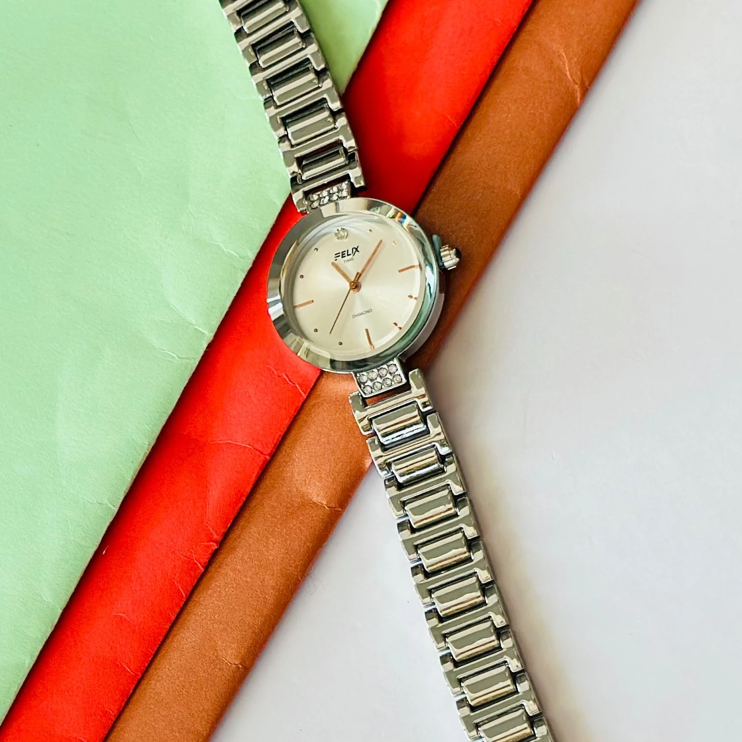 analog watch with a white dial and a rose gold metal strap