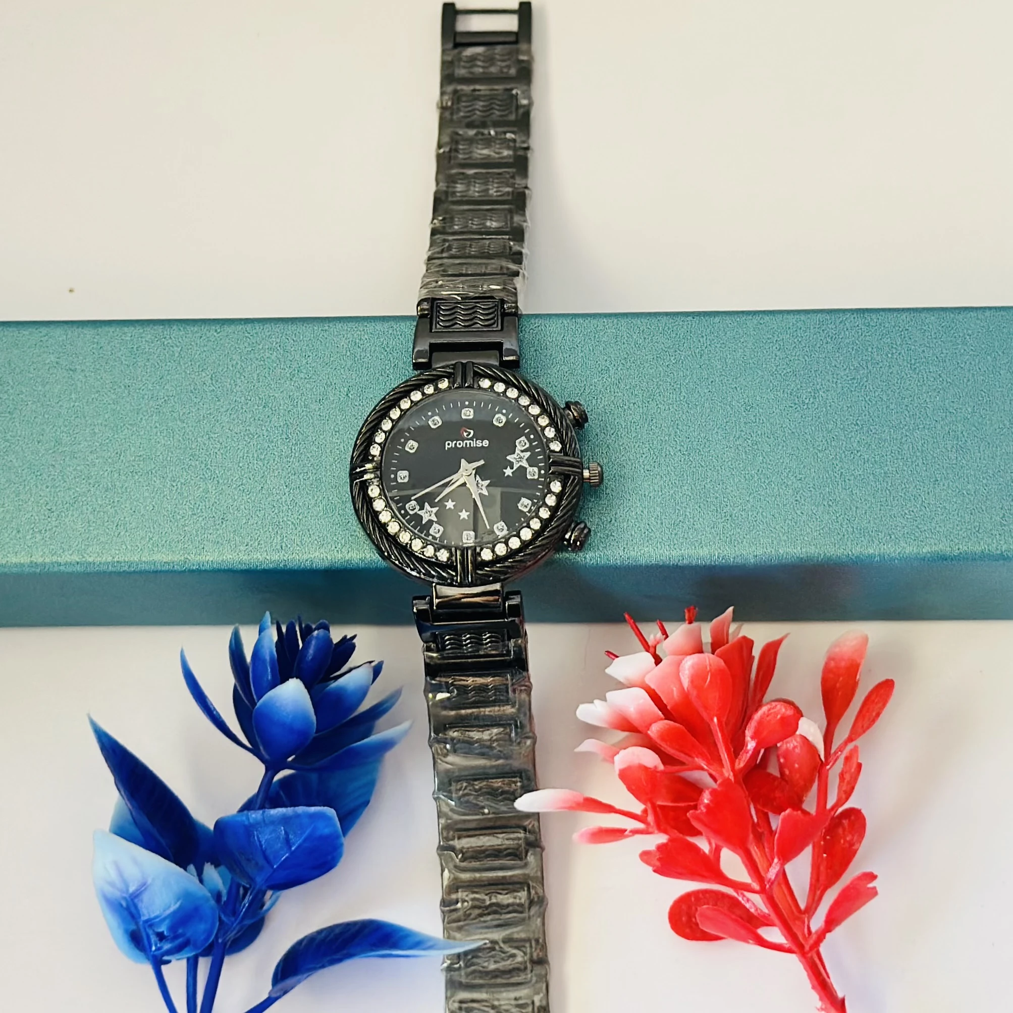Ladies fashion watch with a black metal strap.