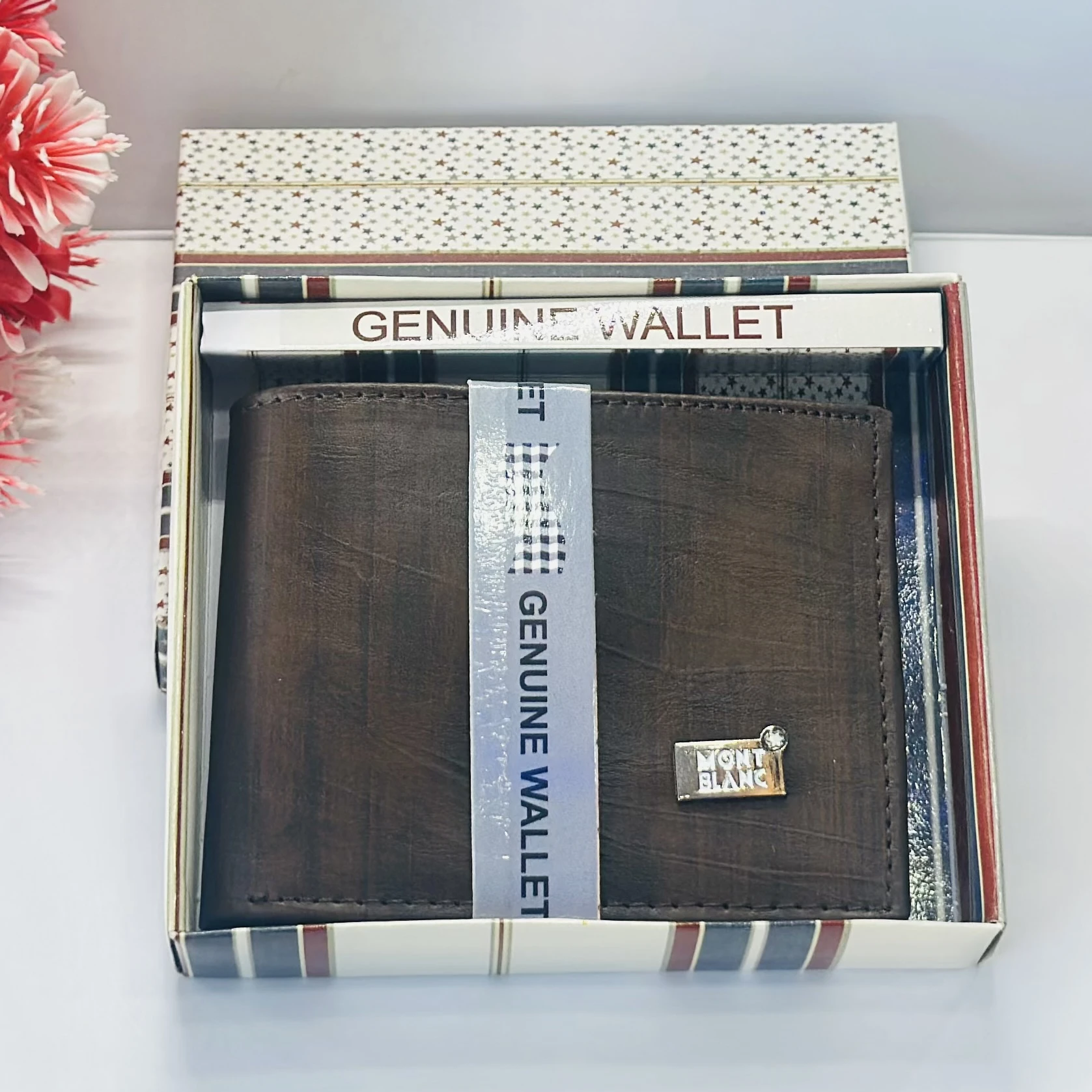 a brown bifold wallet, possibly made of genuine leather, branded as a Montblanc product.