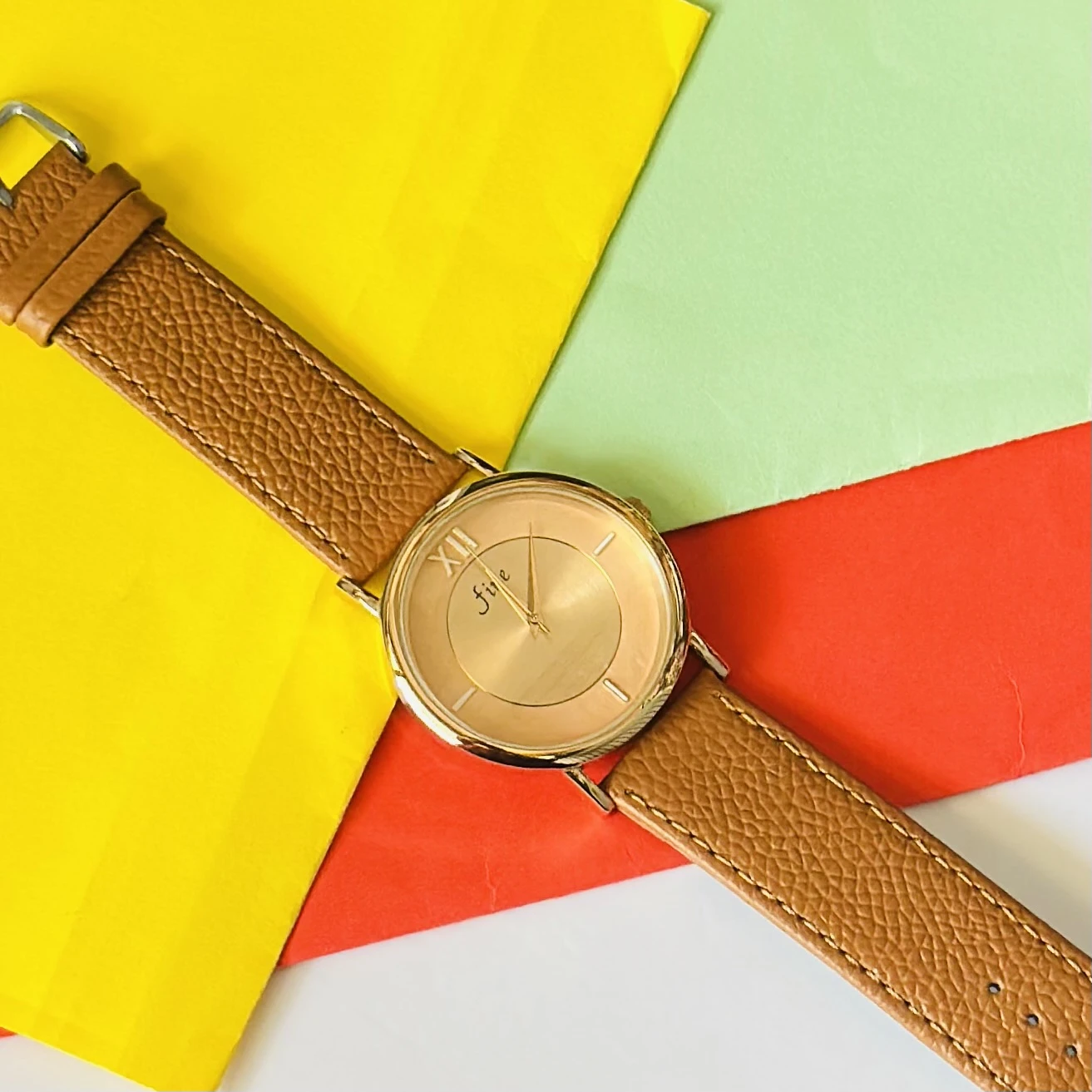 Jule Sun-Kissed watch with a tan faux leather strap and gold-toned details.