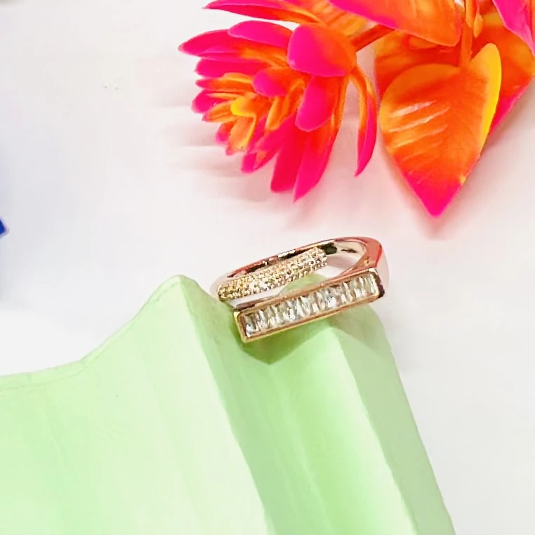 modern minimalist gold ring featuring a baguette diamond bar design.