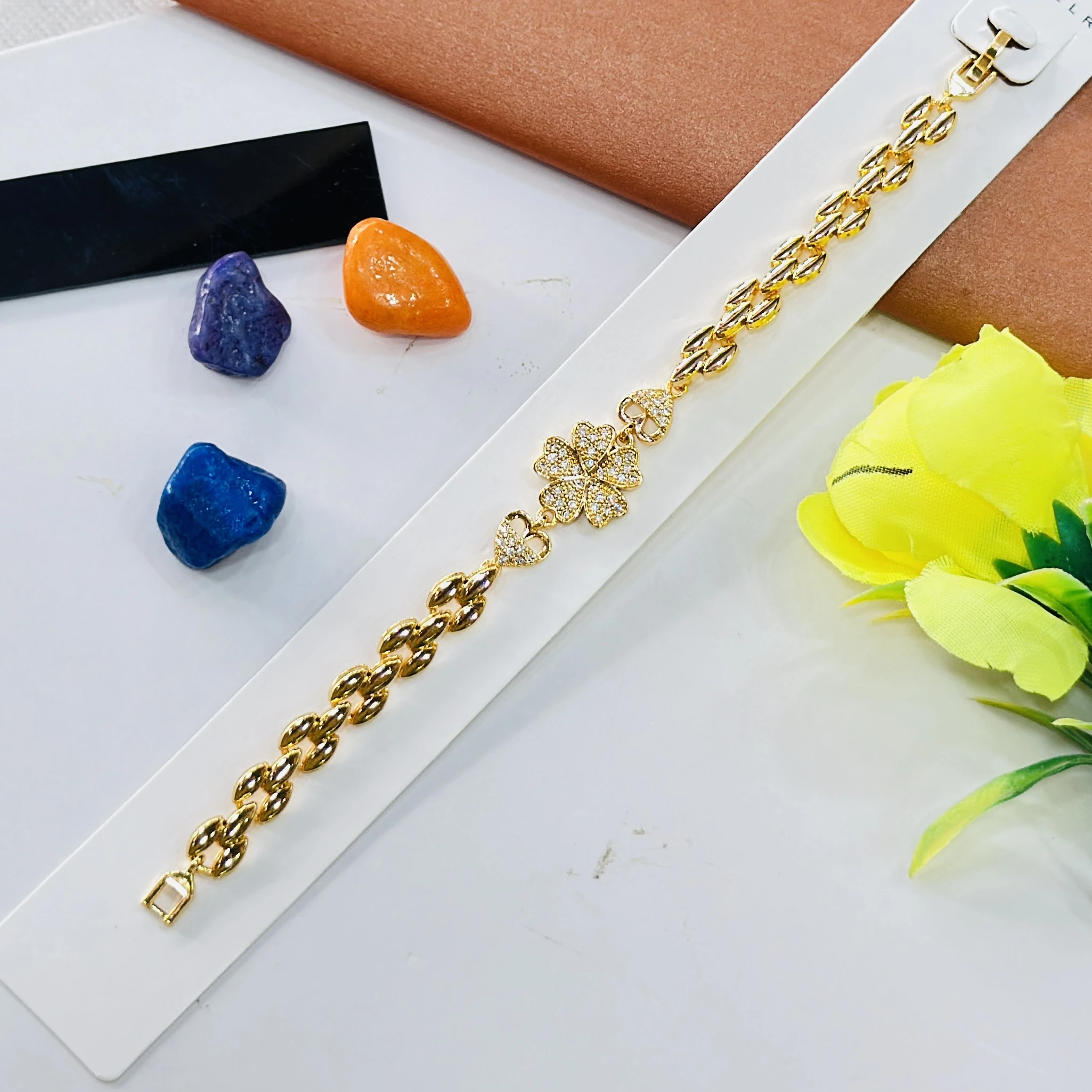Gold plated bracelet with a central clover design