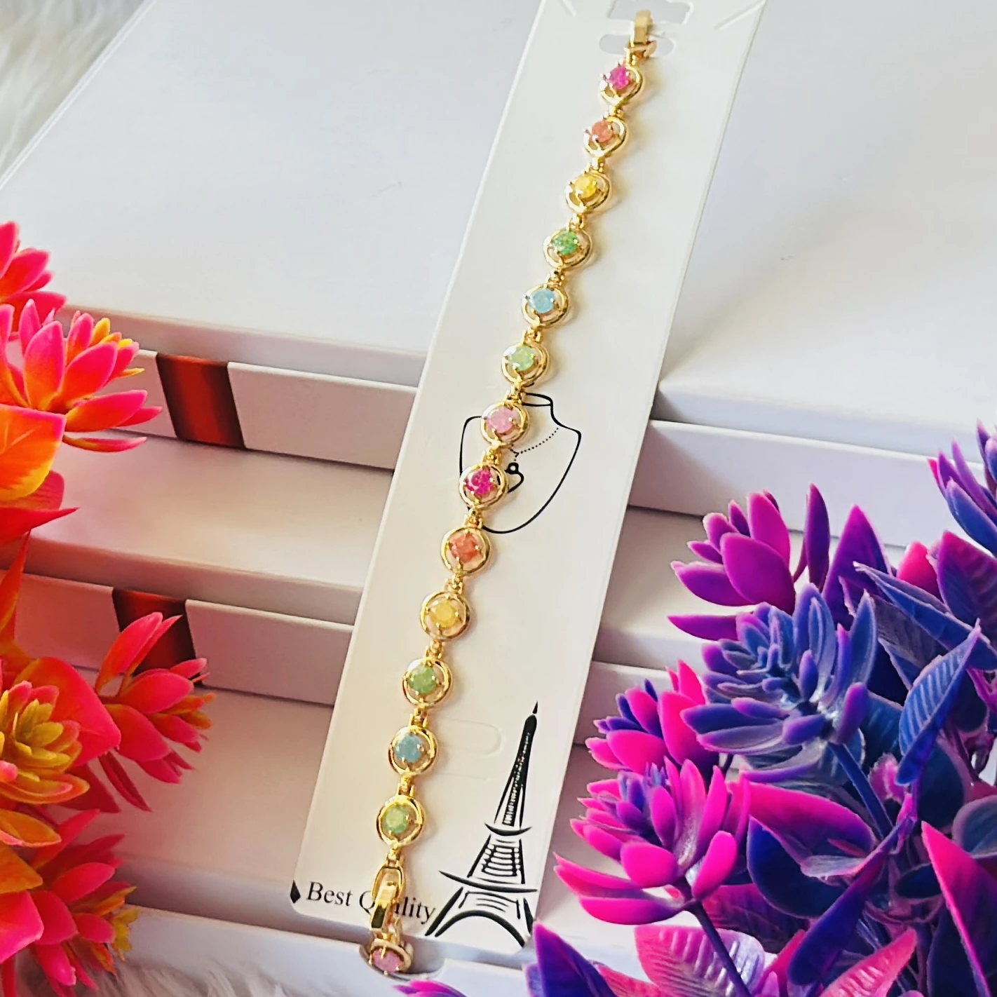 Gold plated chain bracelet with multicolor oval-shaped stones.