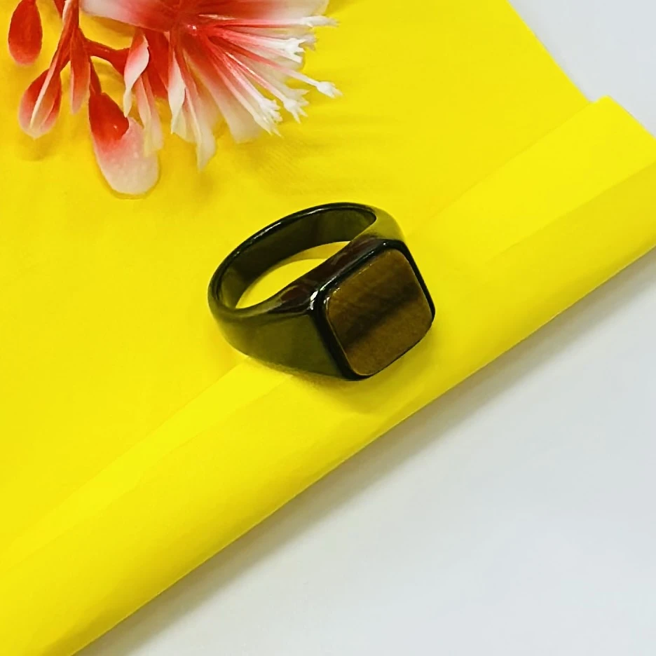 Chimes stainless steel black ring with a square-shaped crystal.