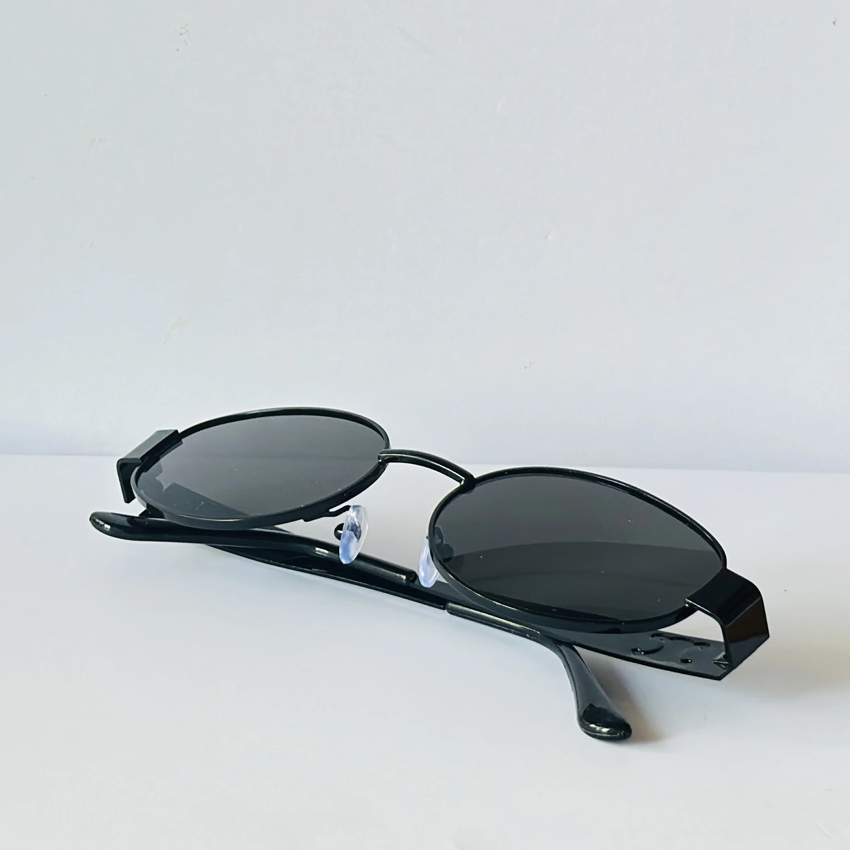 Black sunglasses feature a metal frame and black lenses
