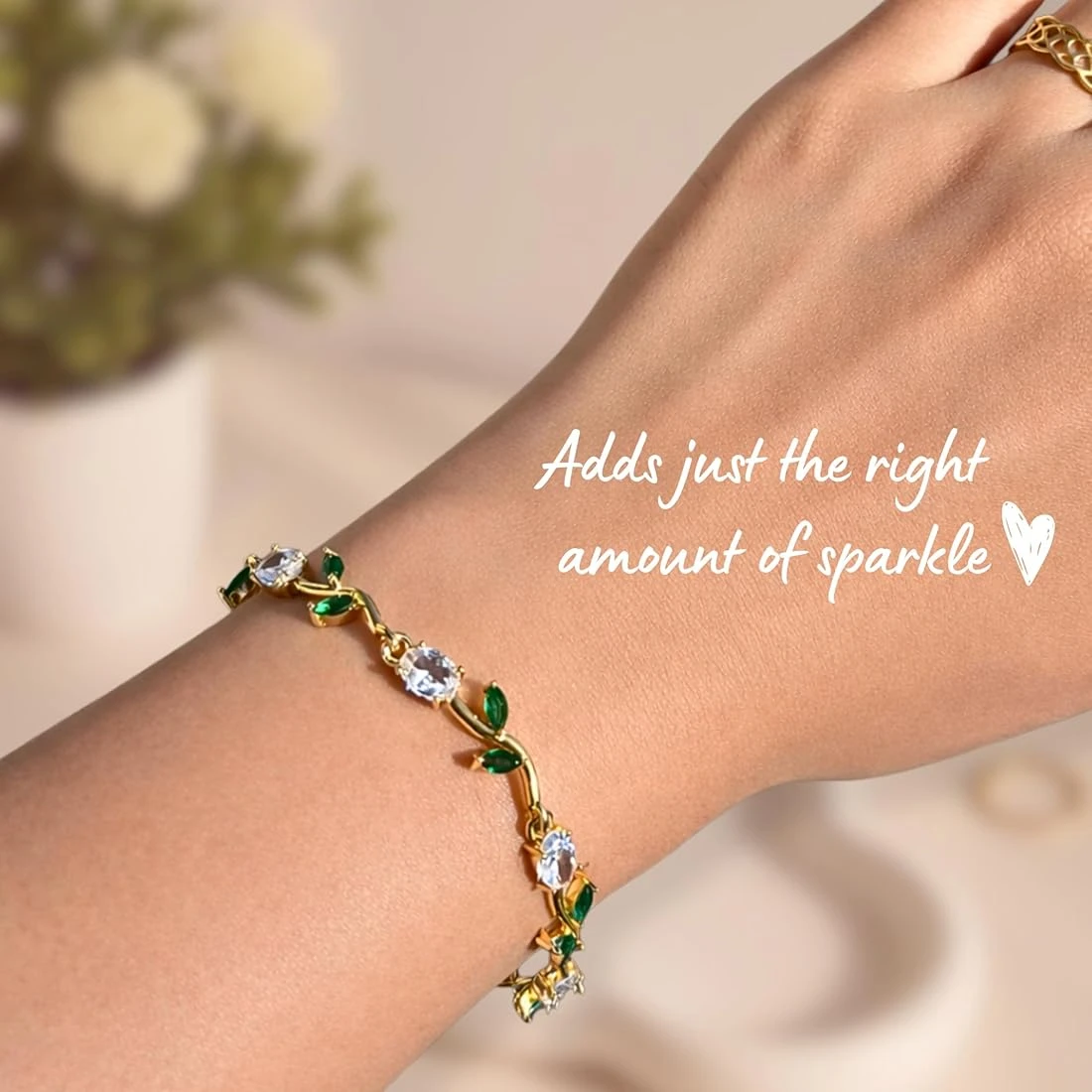 gold plated tulip bracelet featuring white oval crystals and green marquise leaf accents