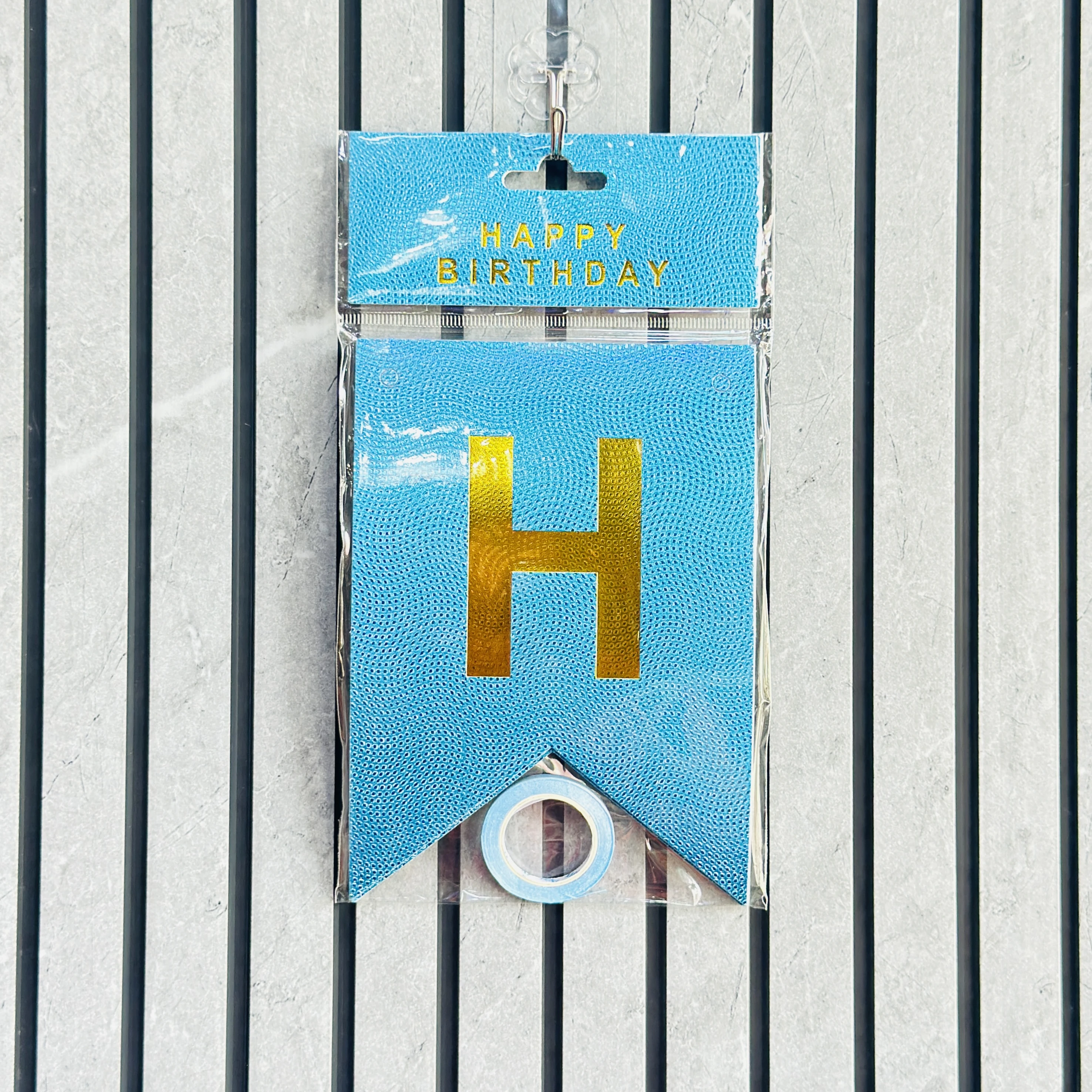 Blue paper Happy Birthday bunting banner with shiny gold foil lettering