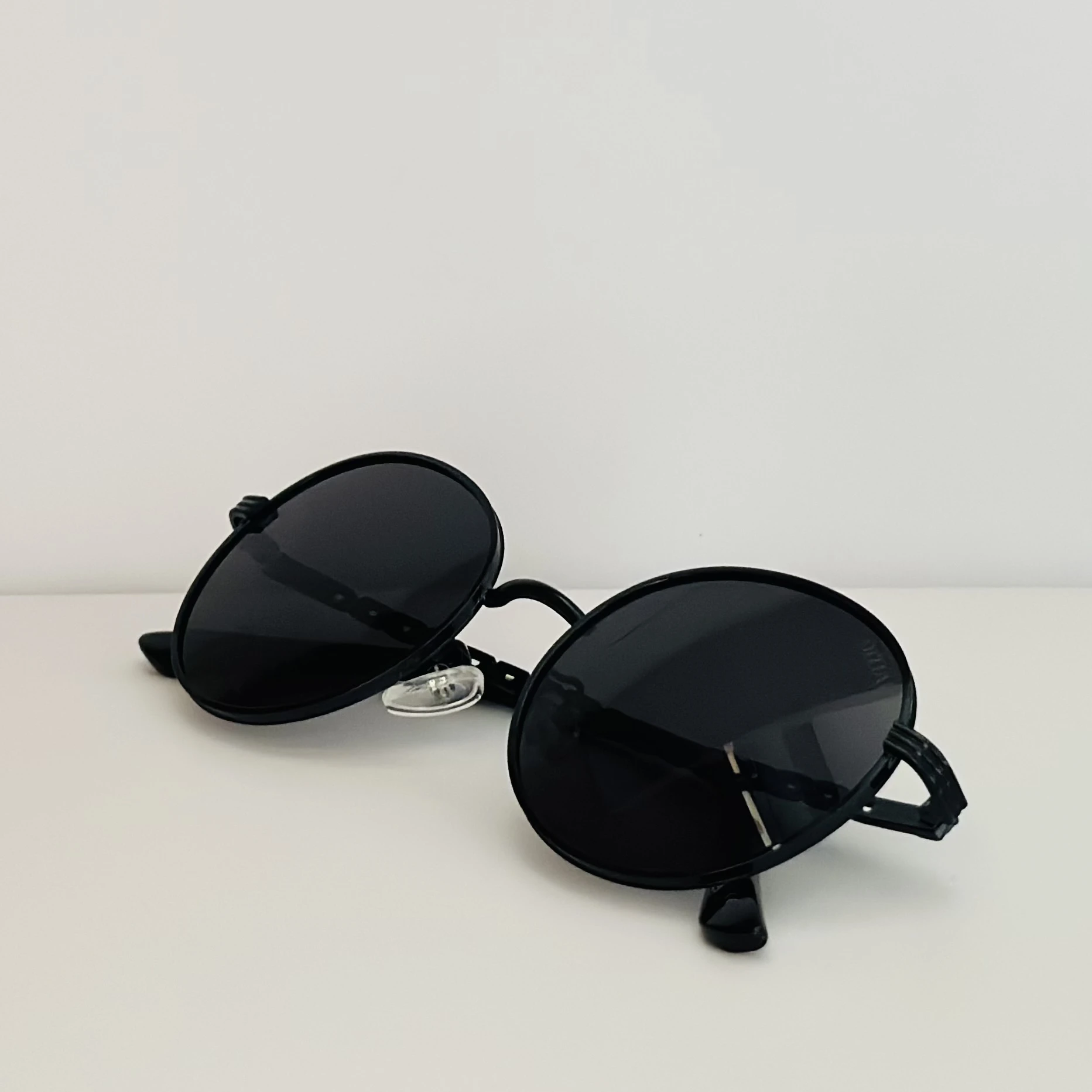 Moncler Tatou ML 0224 sunglasses in black metal with round lenses.