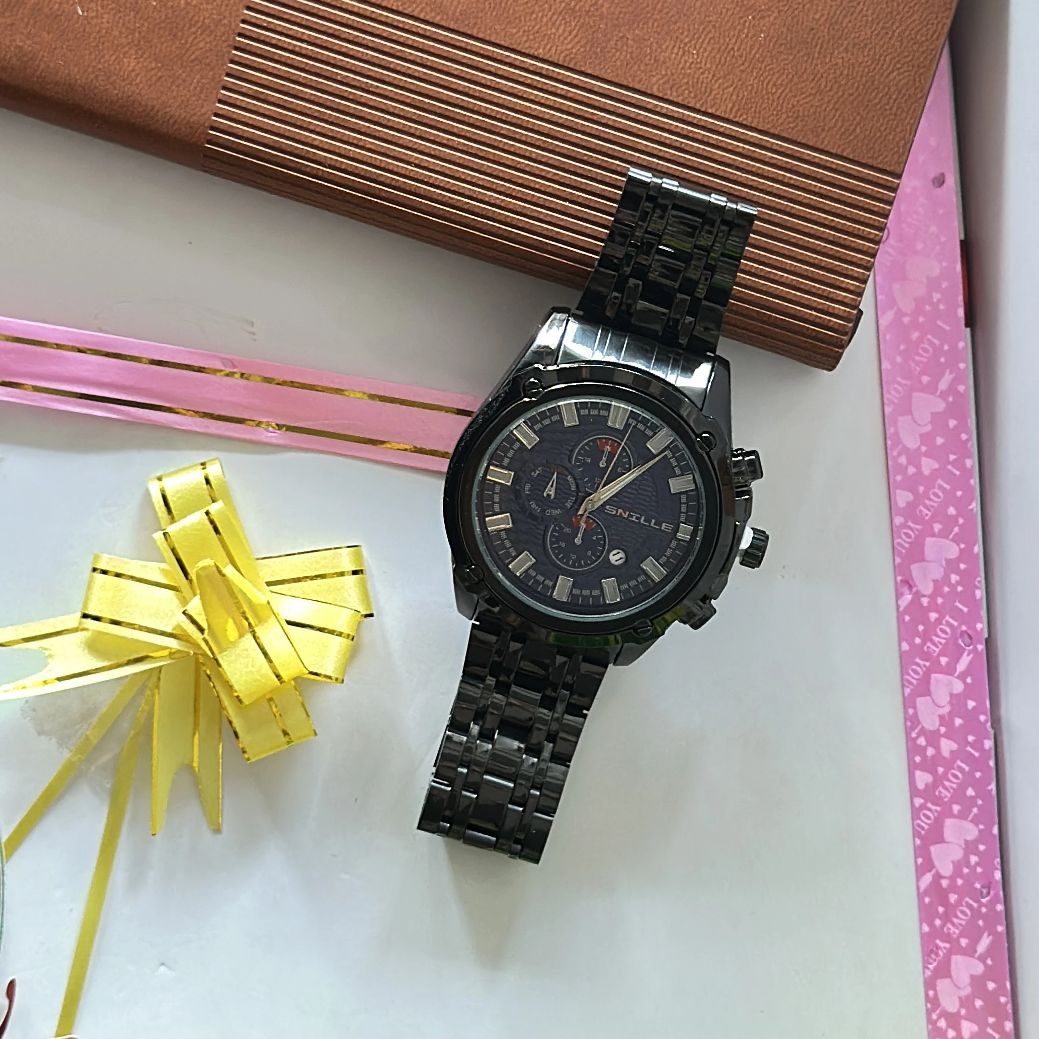 Snille brand wristwatch features a black analog