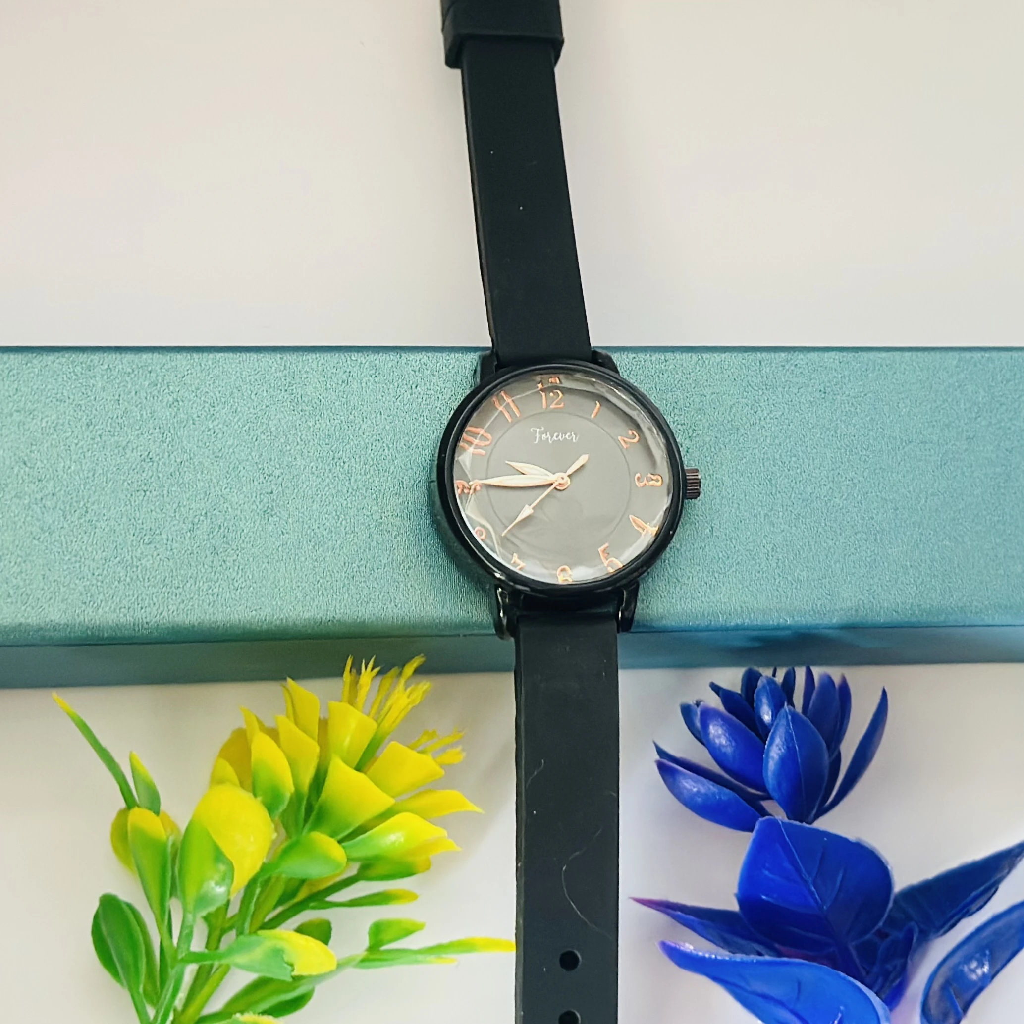 women's analog quartz watch with a white dial and black strap.