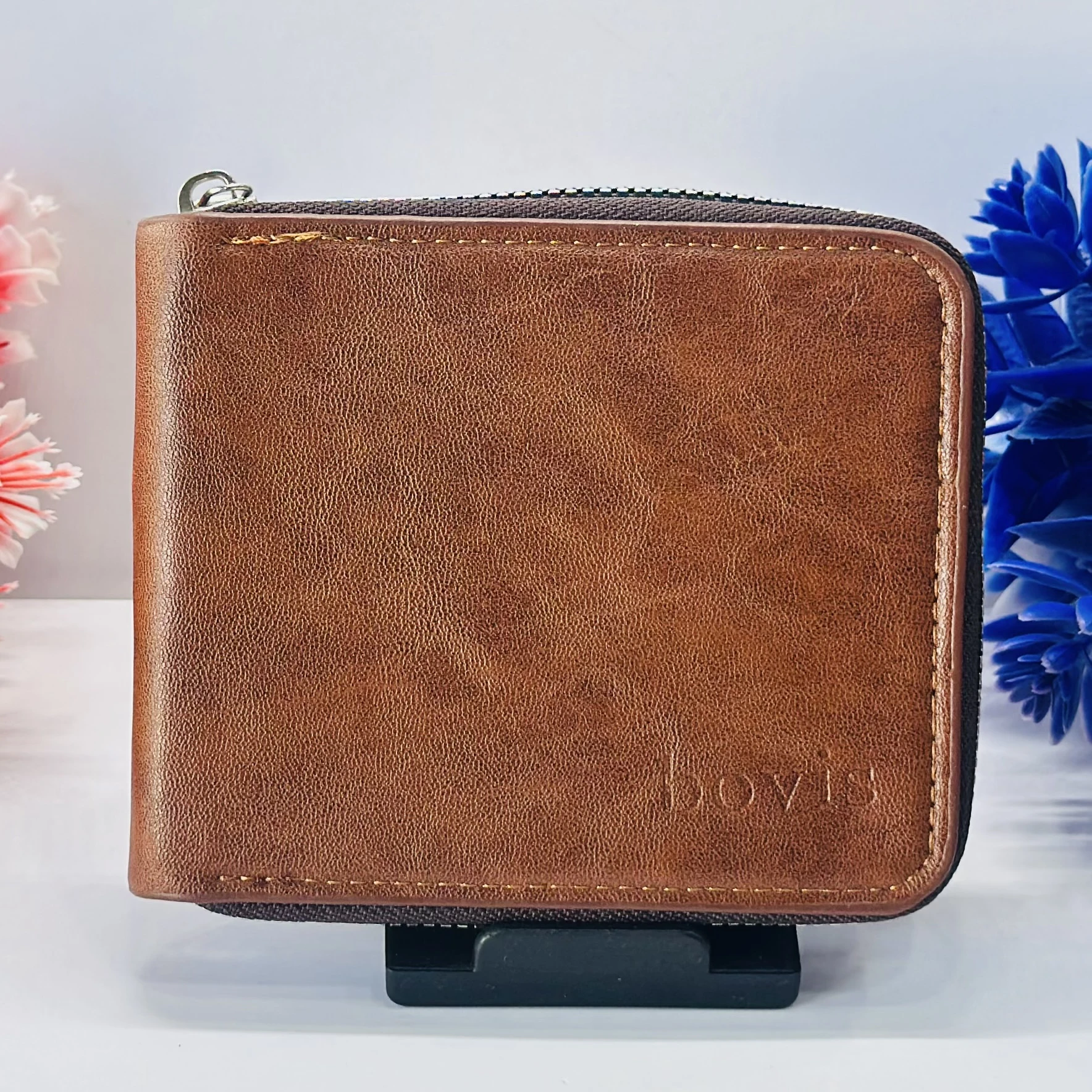 brown leather zip-around wallet with a "bovis" logo.