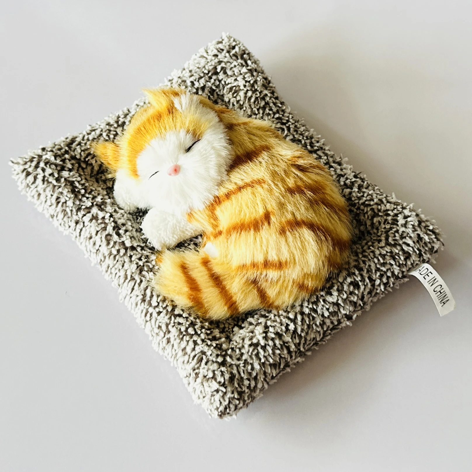 plush toy depicting a sleeping cat