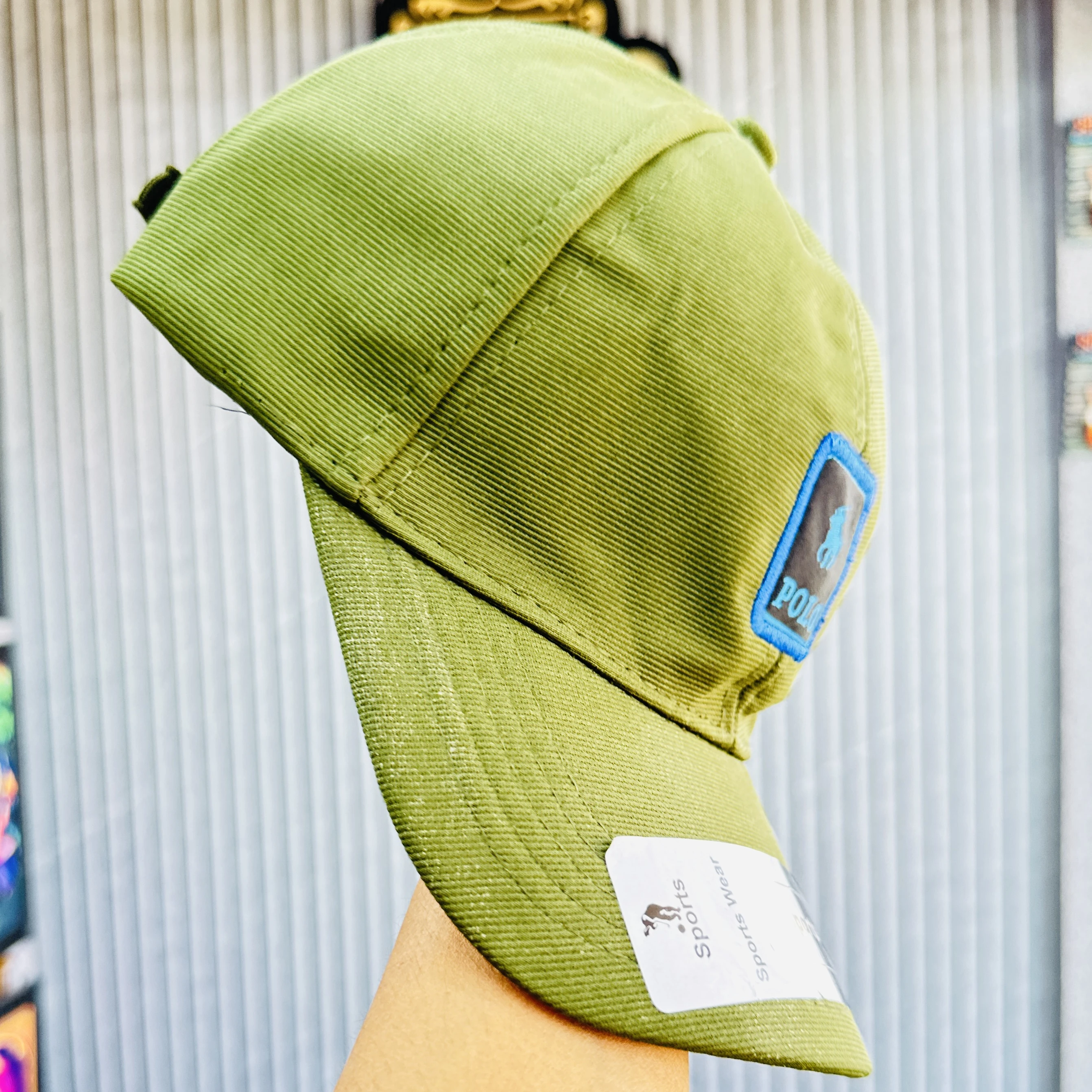 appears to be a green cotton blend baseball cap