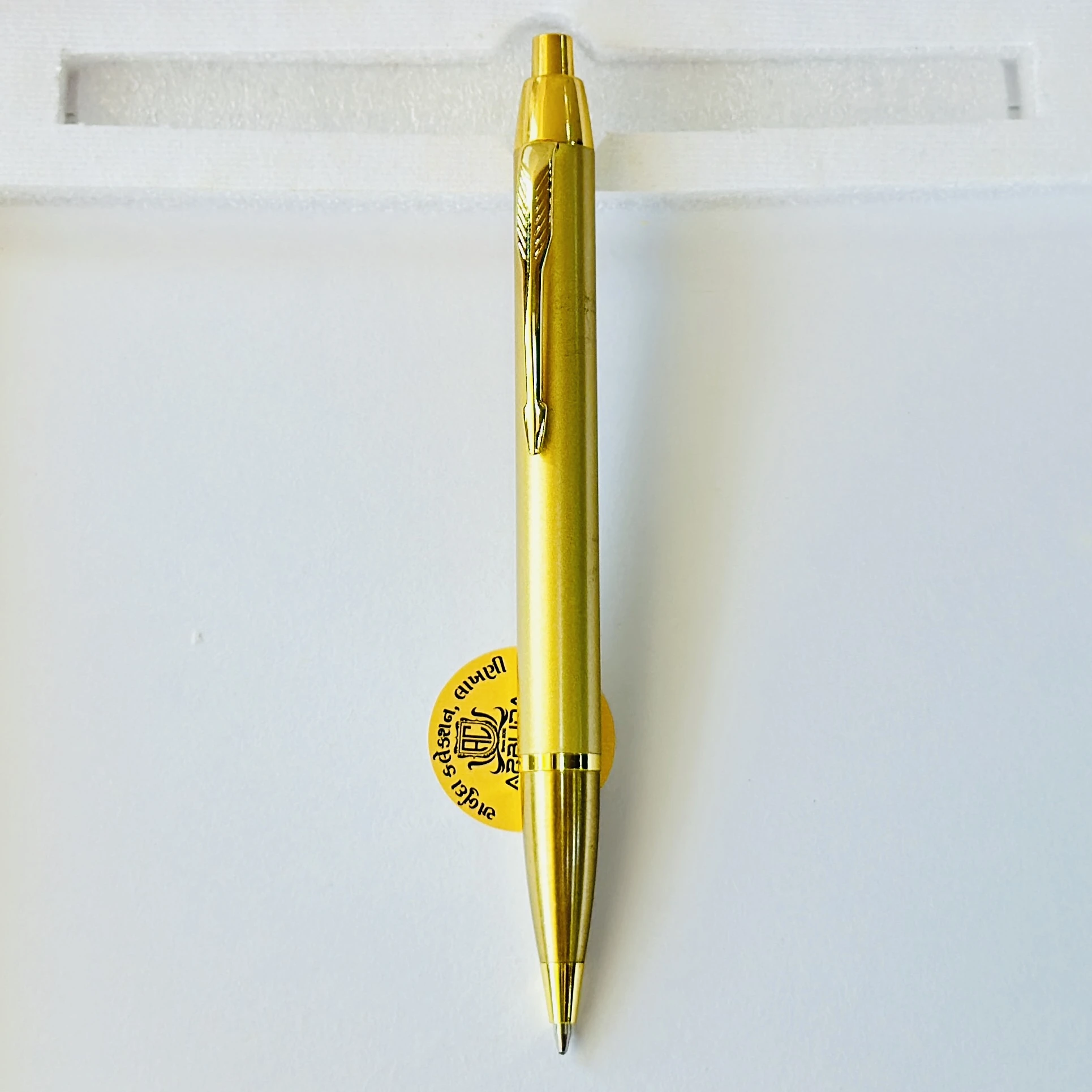 Gold colored metal click ballpoint pen.