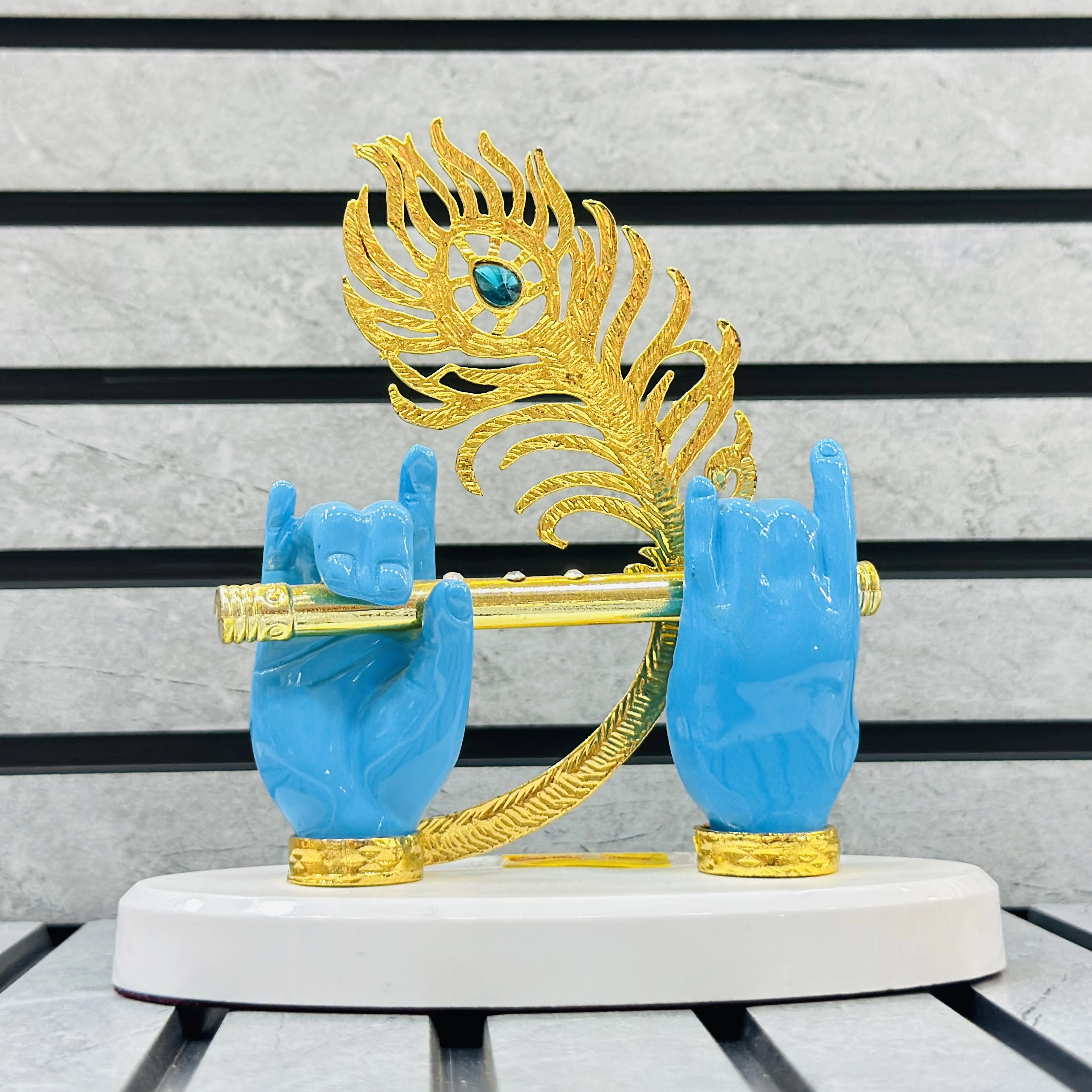 Gold plated Lord Krishna hands with flute and peacock feather figurine.