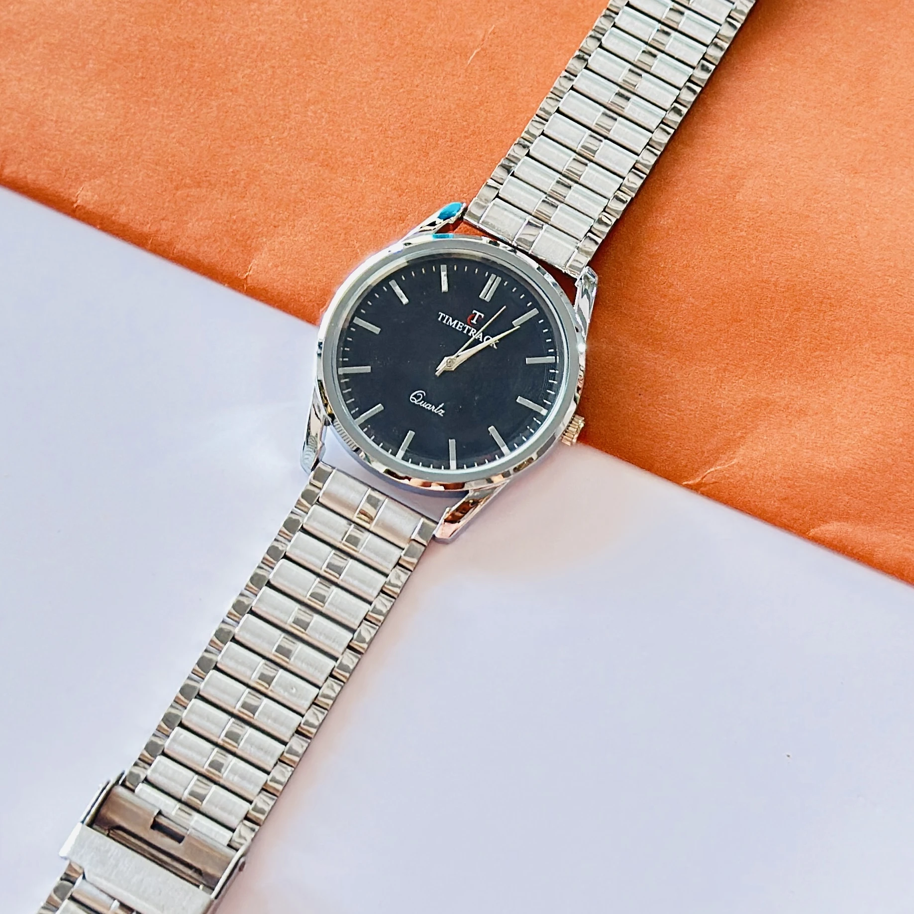 Silver coloured analogue watch