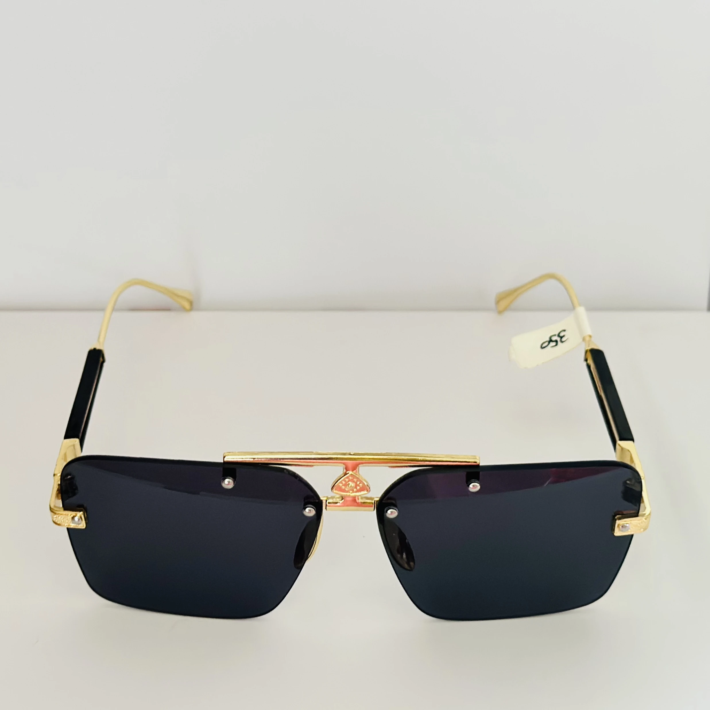 Maybach square gold-framed sunglasses with black lenses.