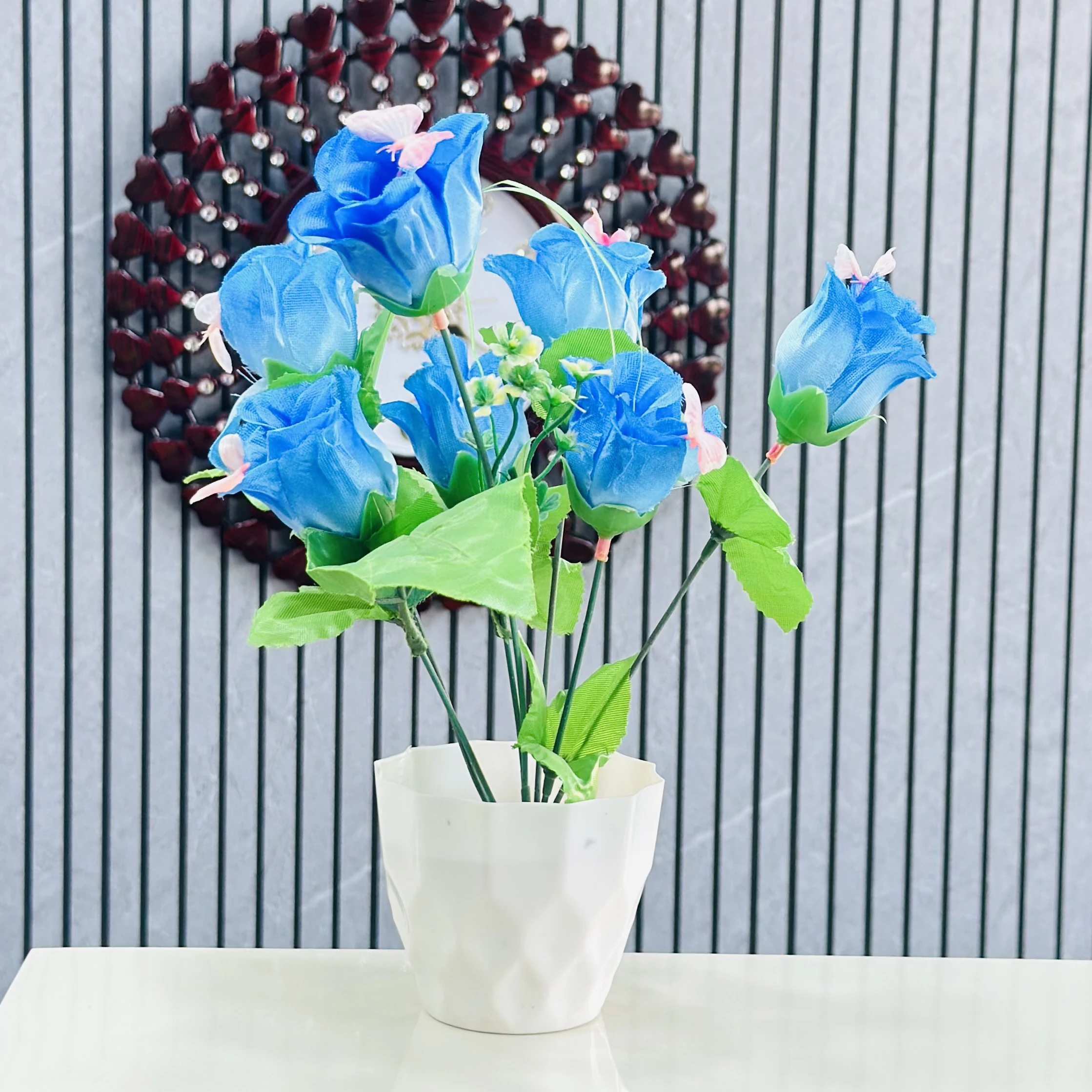 Blue rose flower bunch in a white plastic pot.
