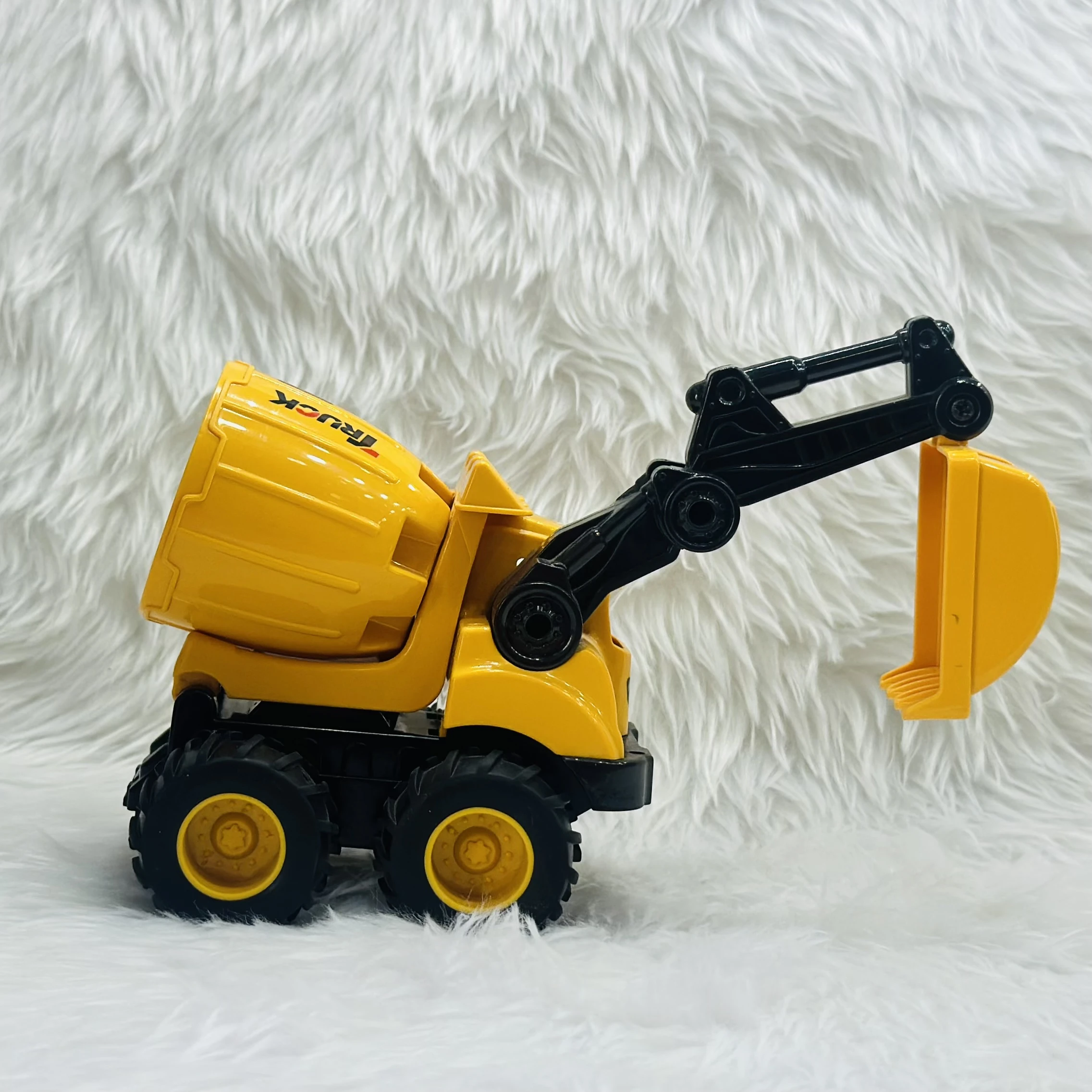 Cement mixer with an attached excavator arm.