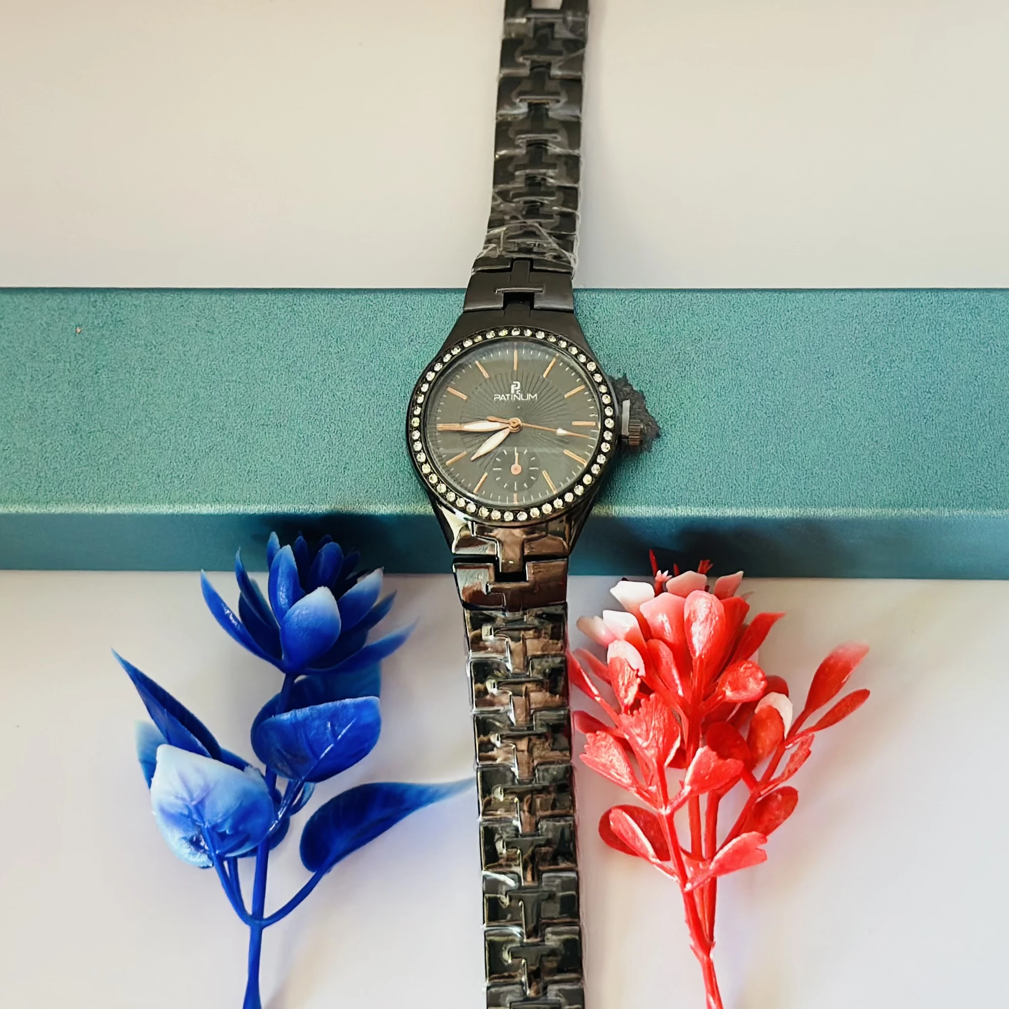 ceramic watch with a black dial and diamond-set bezel.