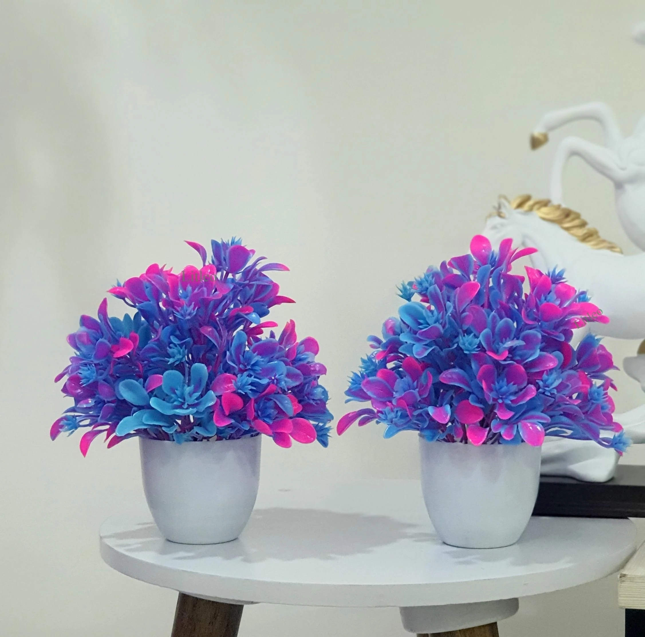 set of artificial potted plants with pink and blue leaves.