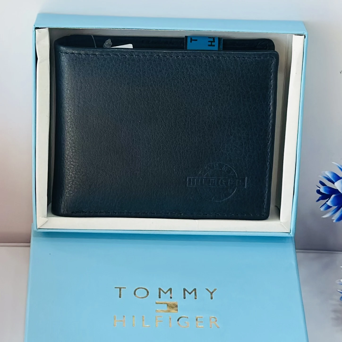 Blue Tommy Hilfiger men's genuine leather bi-fold wallet.